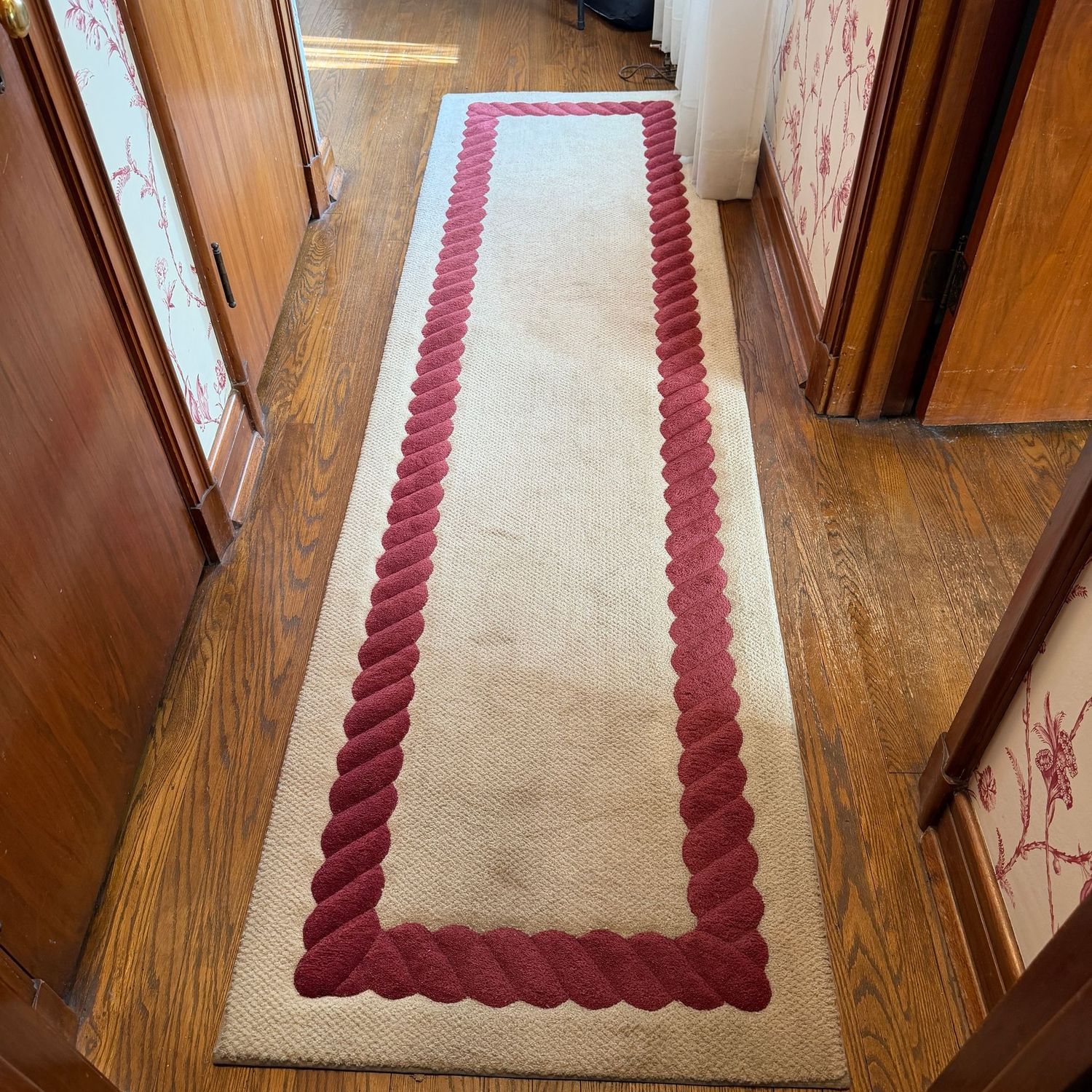 Cream Masland custom hall carpet with deep red rope border, 9' x 30"