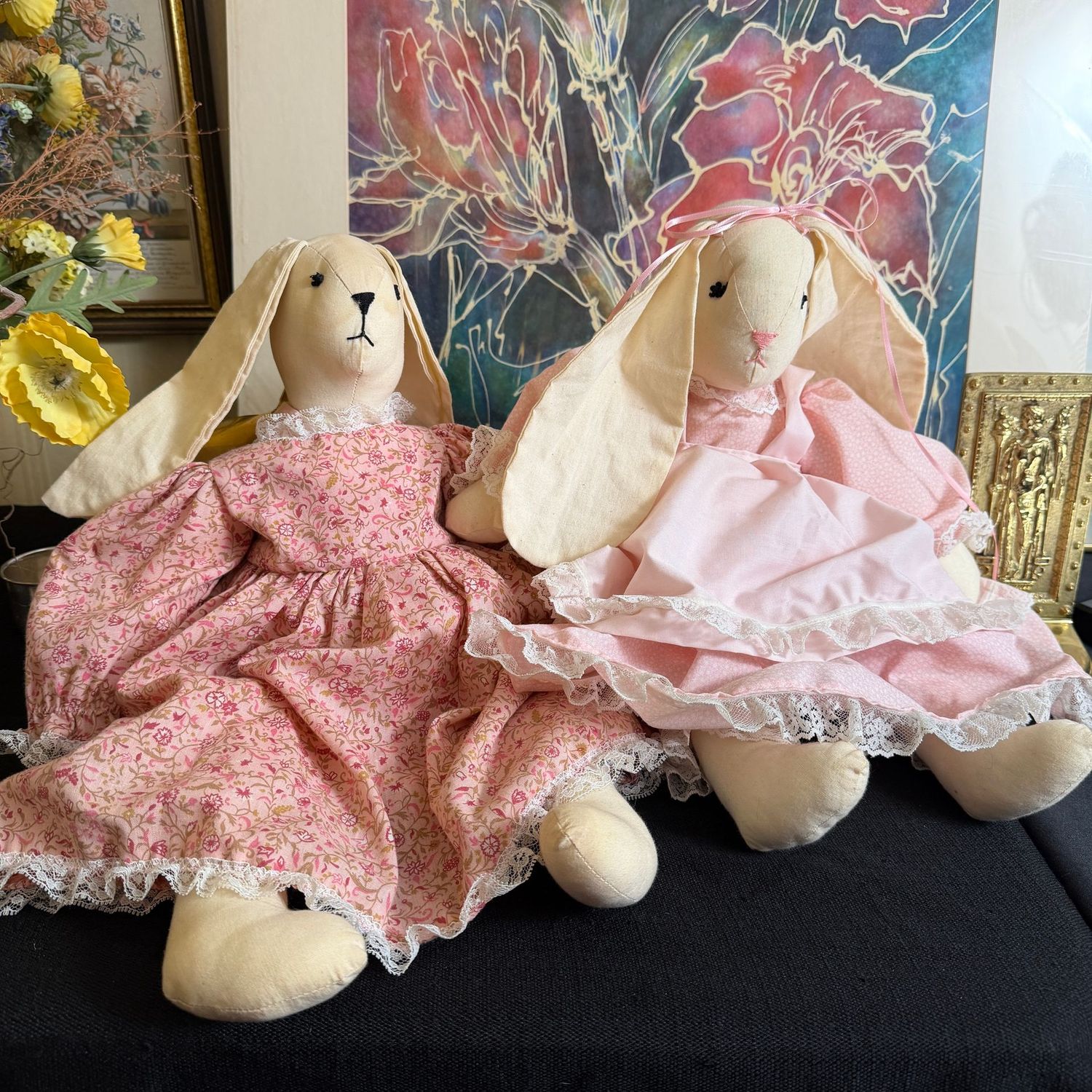 Cloth bunny rabbits in pink dresses, some wear, the tallest is 18"
