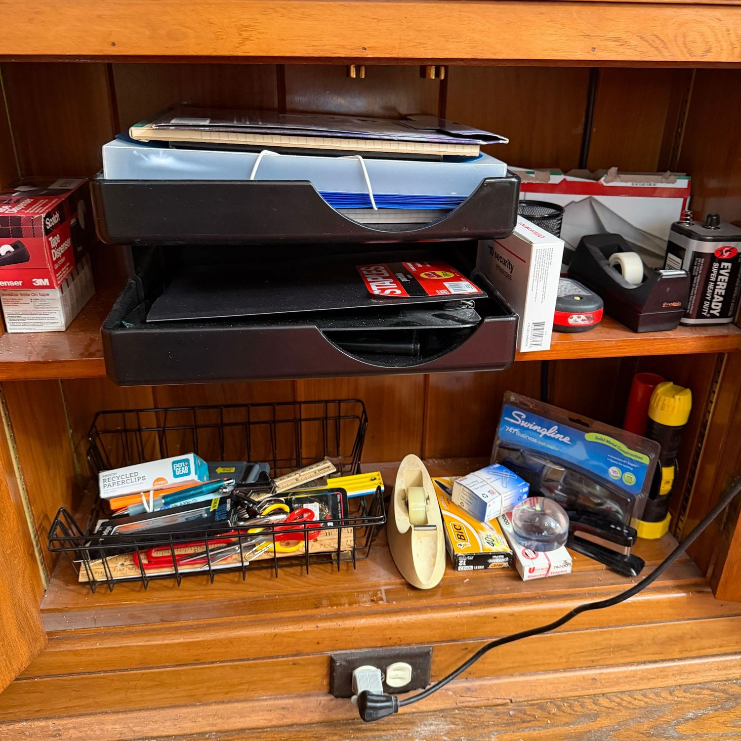 Cabinet of office supplies, tape rollers, staplers, paperweight, envelopes, paper trays, rulers, and more