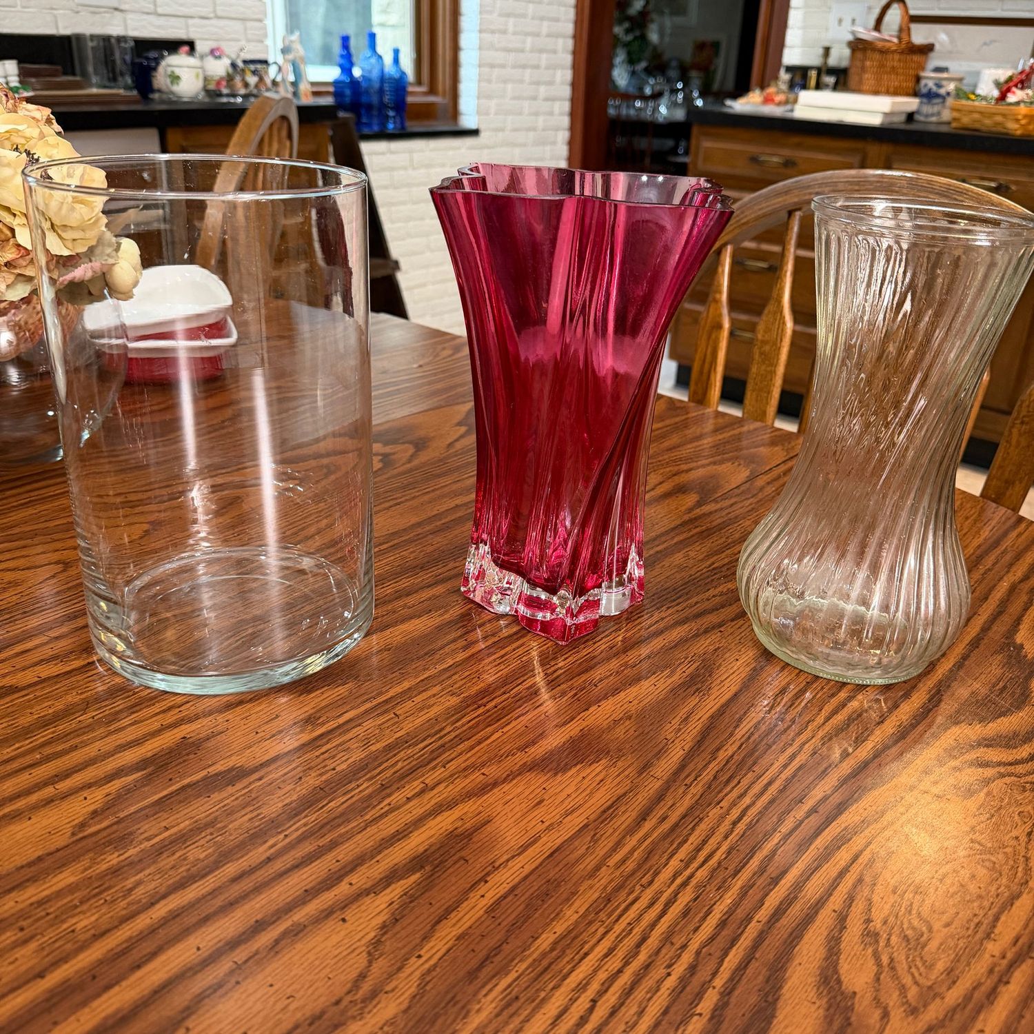 Three full-size glass flower vases, 10"H