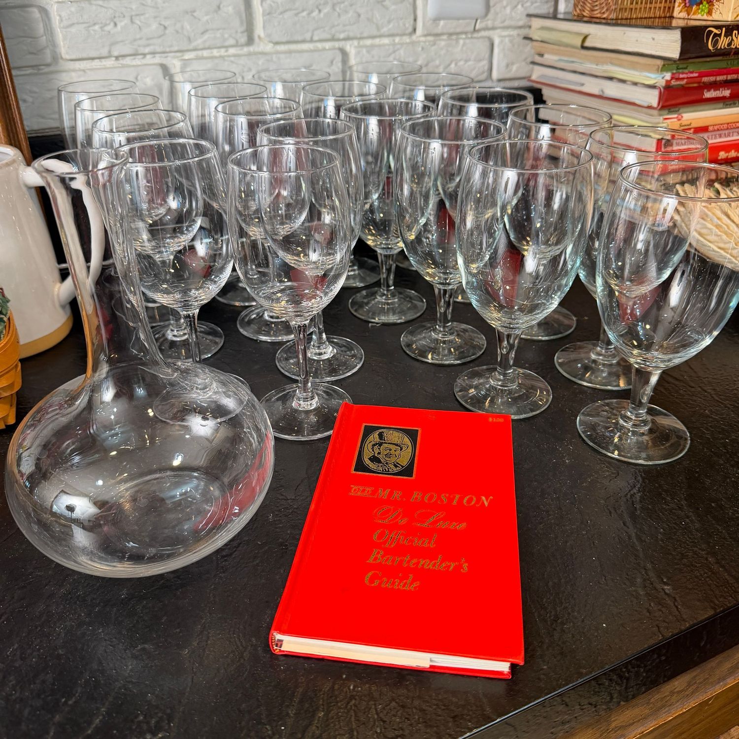 Group of stemware, decanter, and Mr. Boston Bartender's Guide