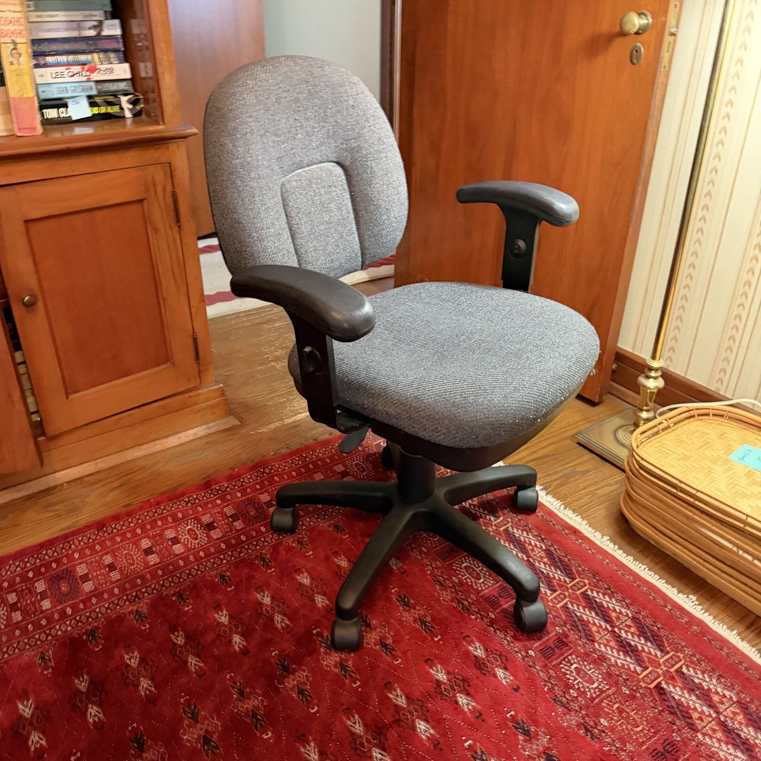 Grey office work chair, adjustable, some wear, rolls and sits well, seat is 18"W