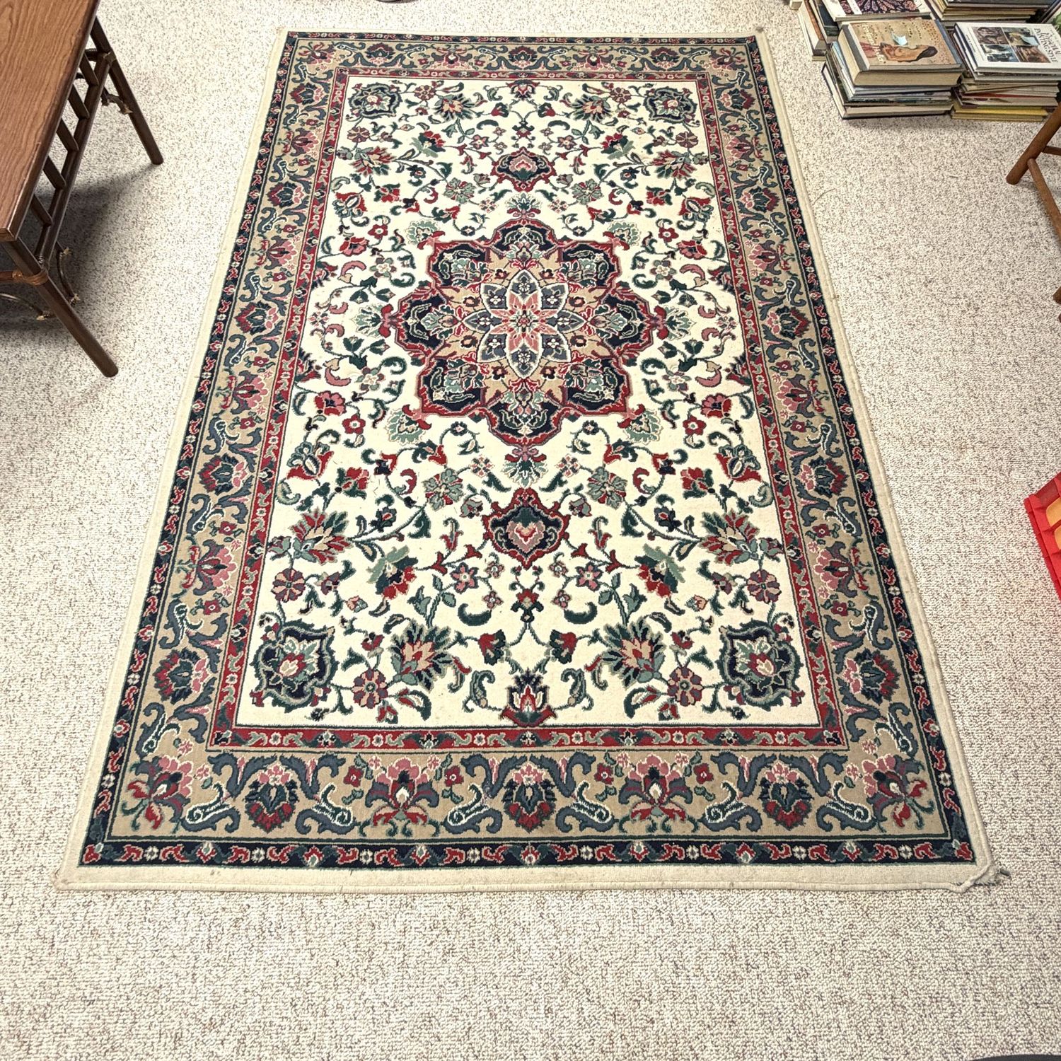 Kashan-style olefin (synthetic) rug in cream, tan, pink, deep red, and blue, some wear but mostly to edges, 60" x 96"