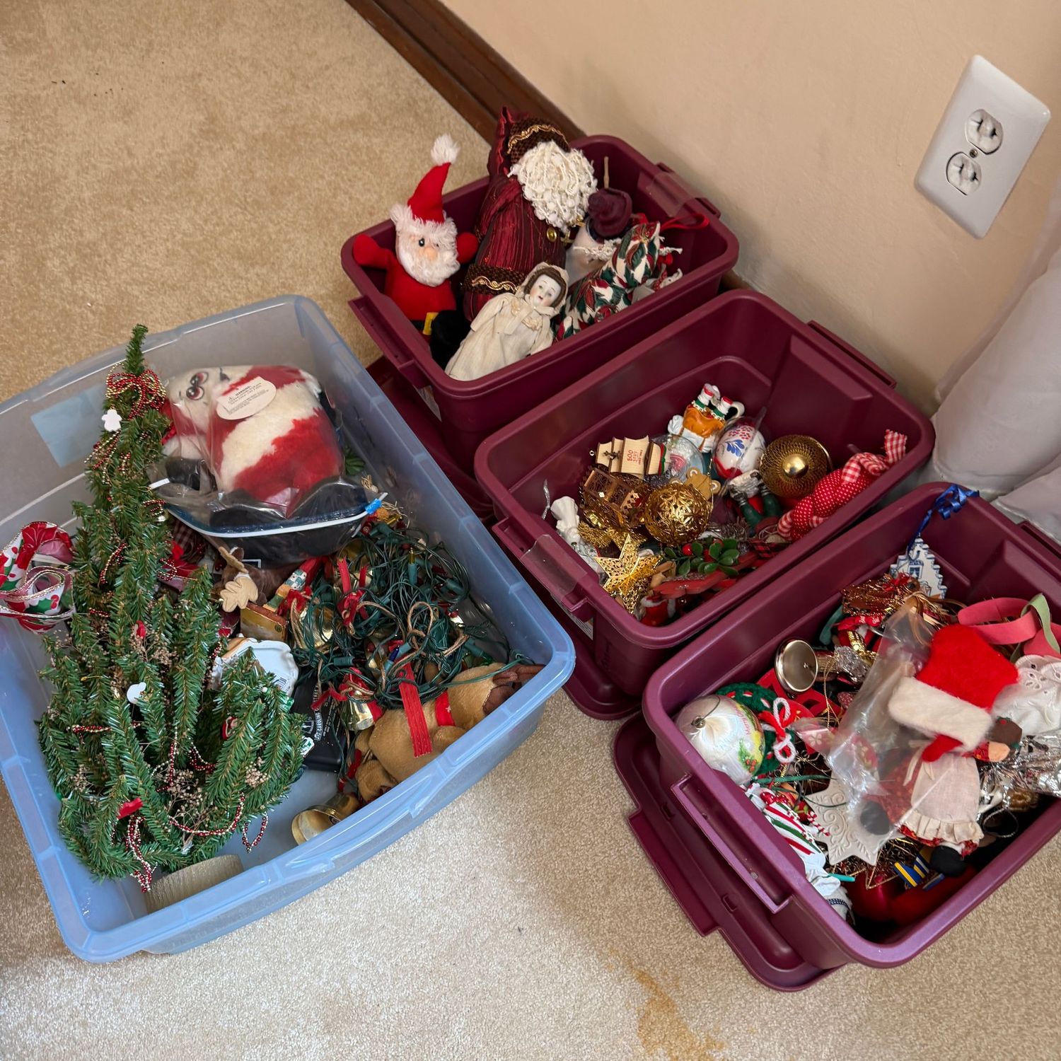 Four small bins of lovely Christmas ornaments, lights, and small decorations. The burgundy bins have lids and are very nice Four small bins of lovely Christmas ornaments, lights, and small decorations. The burgundy bins have lids and are very nice