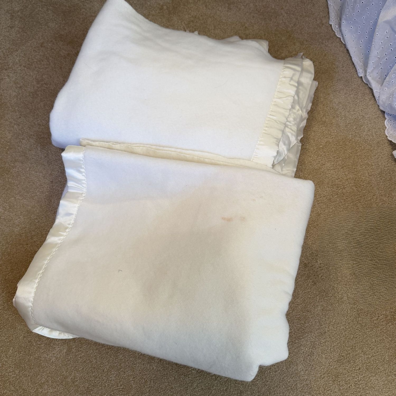 Two twin blankets with satin trim, some wear, a few cleanable spots