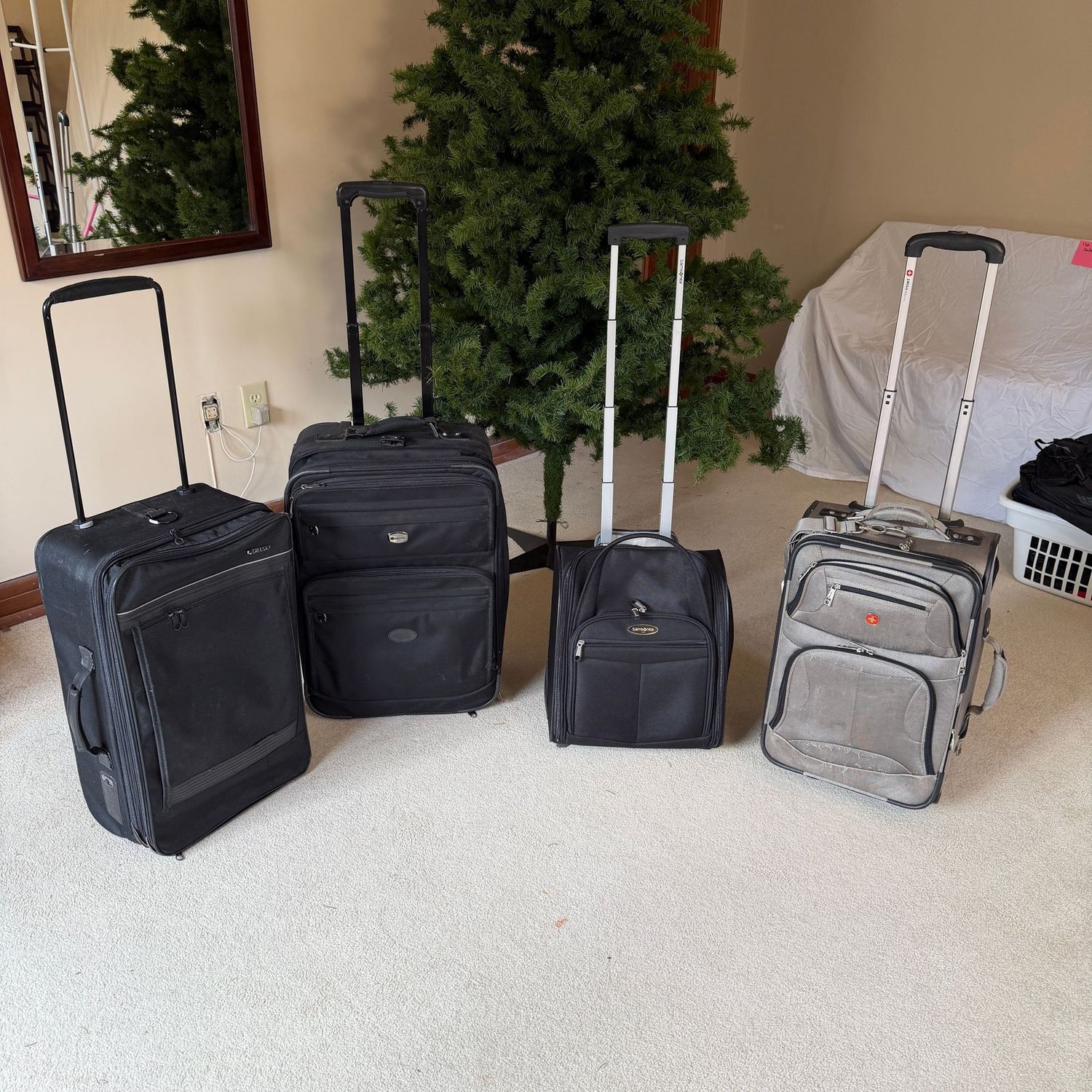Medium-size and carry-on size soft-sided suitcases, handles extend easily, a few have some wear, the largest is 25" x 17"