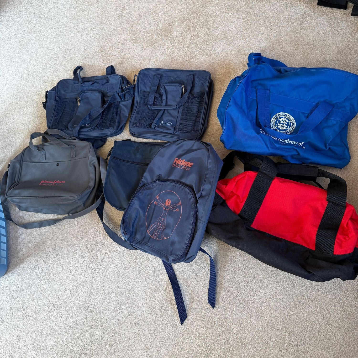 Group of small travel pouches and two small duffel bags