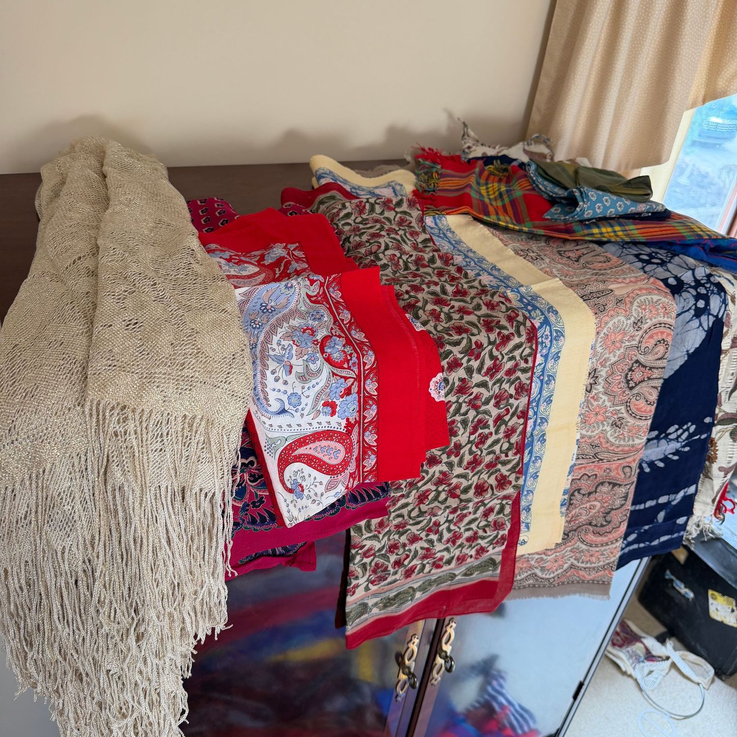 Group of scarves, mostly square, and two fringed shawls