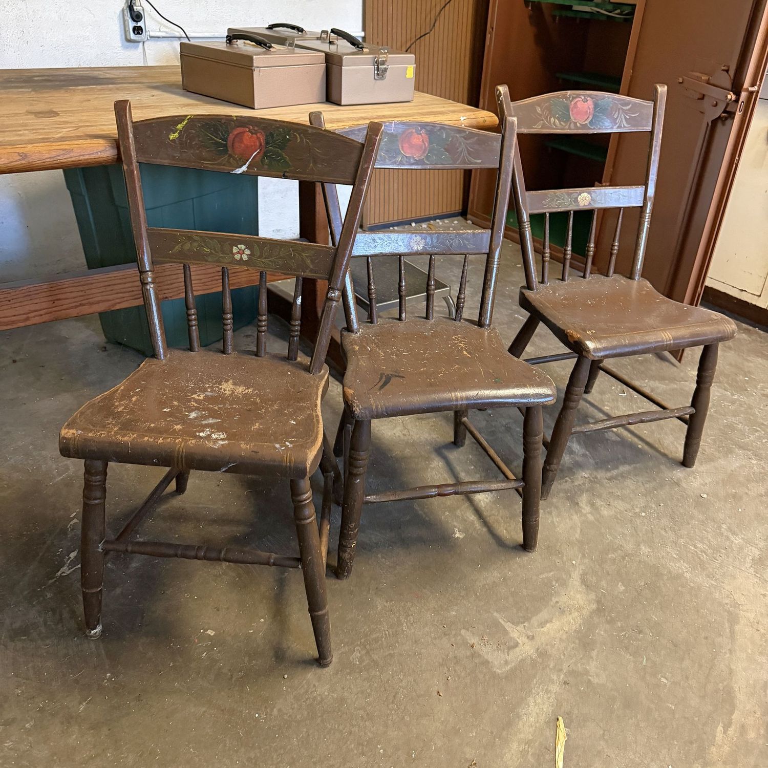 Three plank-bottom chairs with painted backs, all have some additional paint splashes and need some refurbishing, 31"H x 21"W (This item is in the lower level)