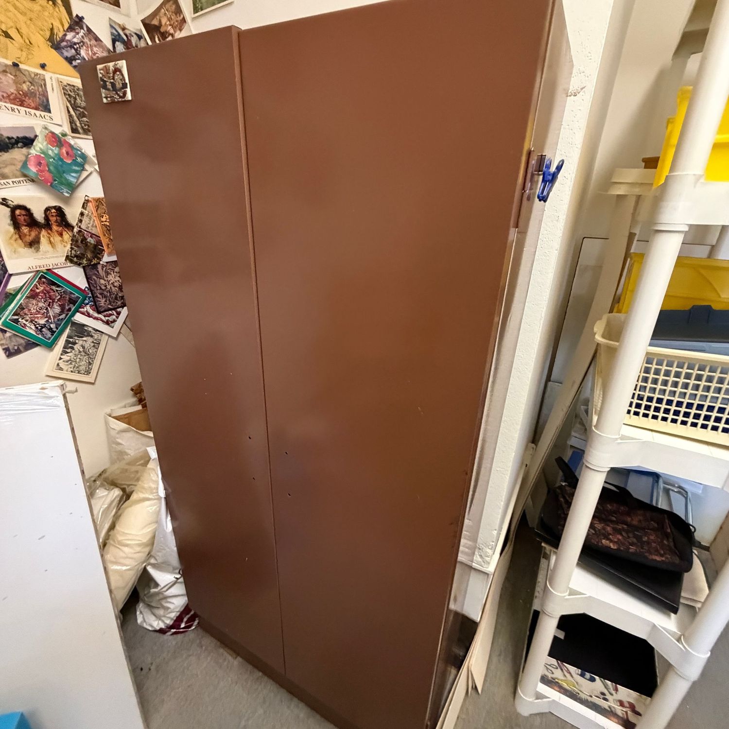 Brown metal 2-door storage cabinet, good condition with minor wear, no handles, 58"H x 29"W x 12"D (This item is heavy and in the lower level)