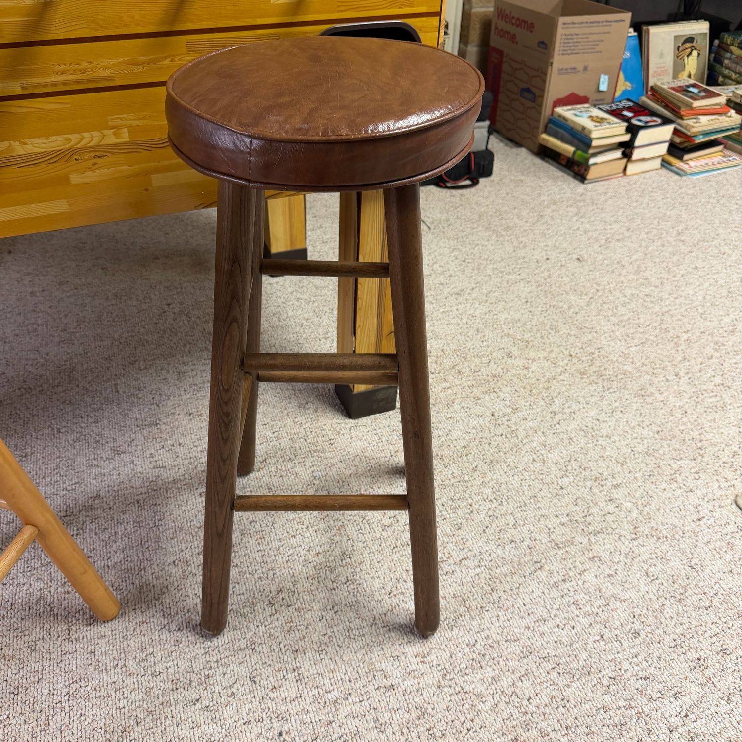 Stool with brown vinyl seat and dark wood legs, 28" x 14"