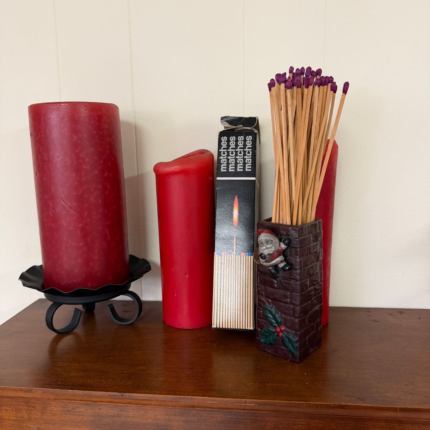 Metal pillar candle holder, pillar candles (some use), and ceramic Santa-on-Chimney fireplace matches holder (and matches)