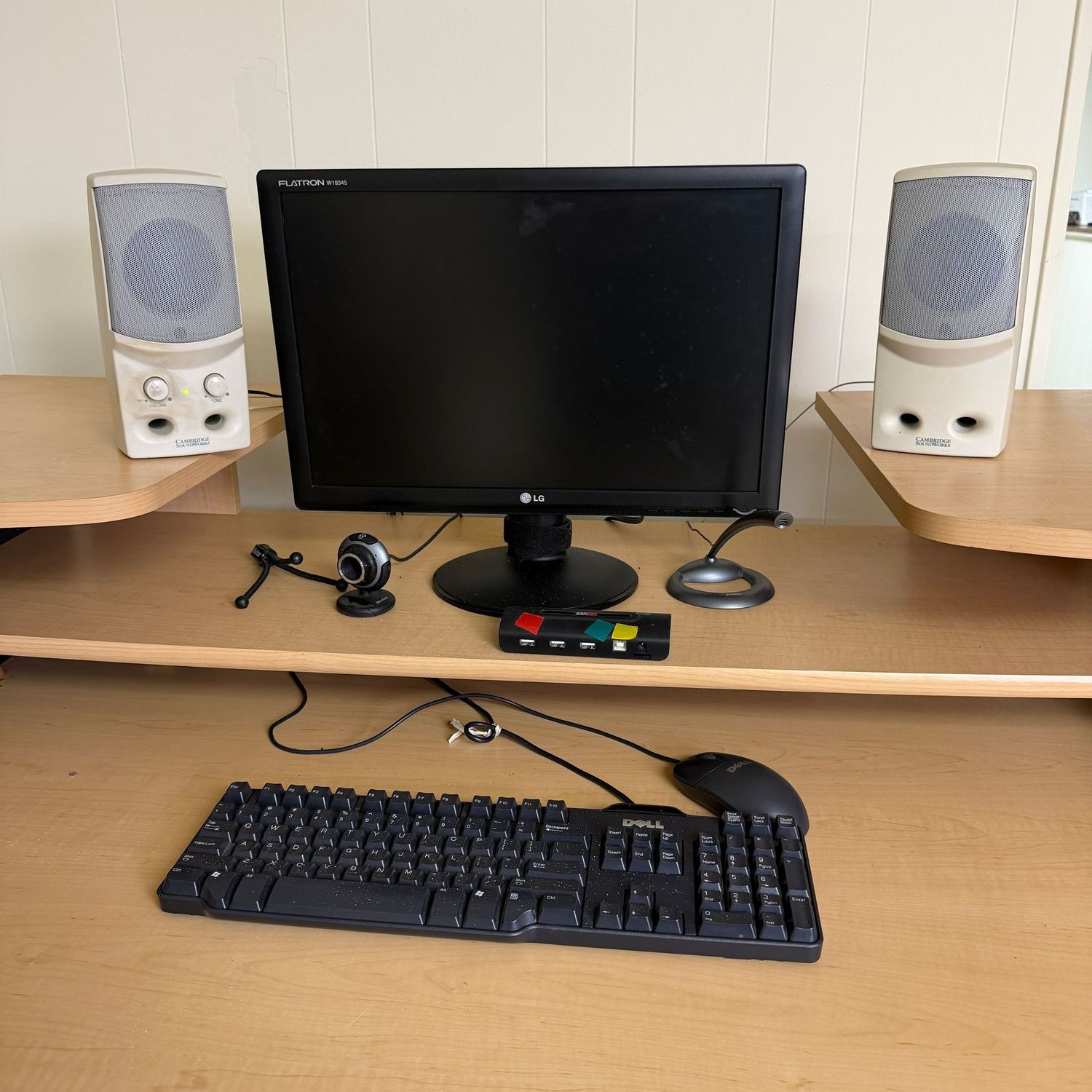 Small computer screen (approx. 19"), speakers (working). Plus, a camera, microphone, keyboard, and mouse (not tested)