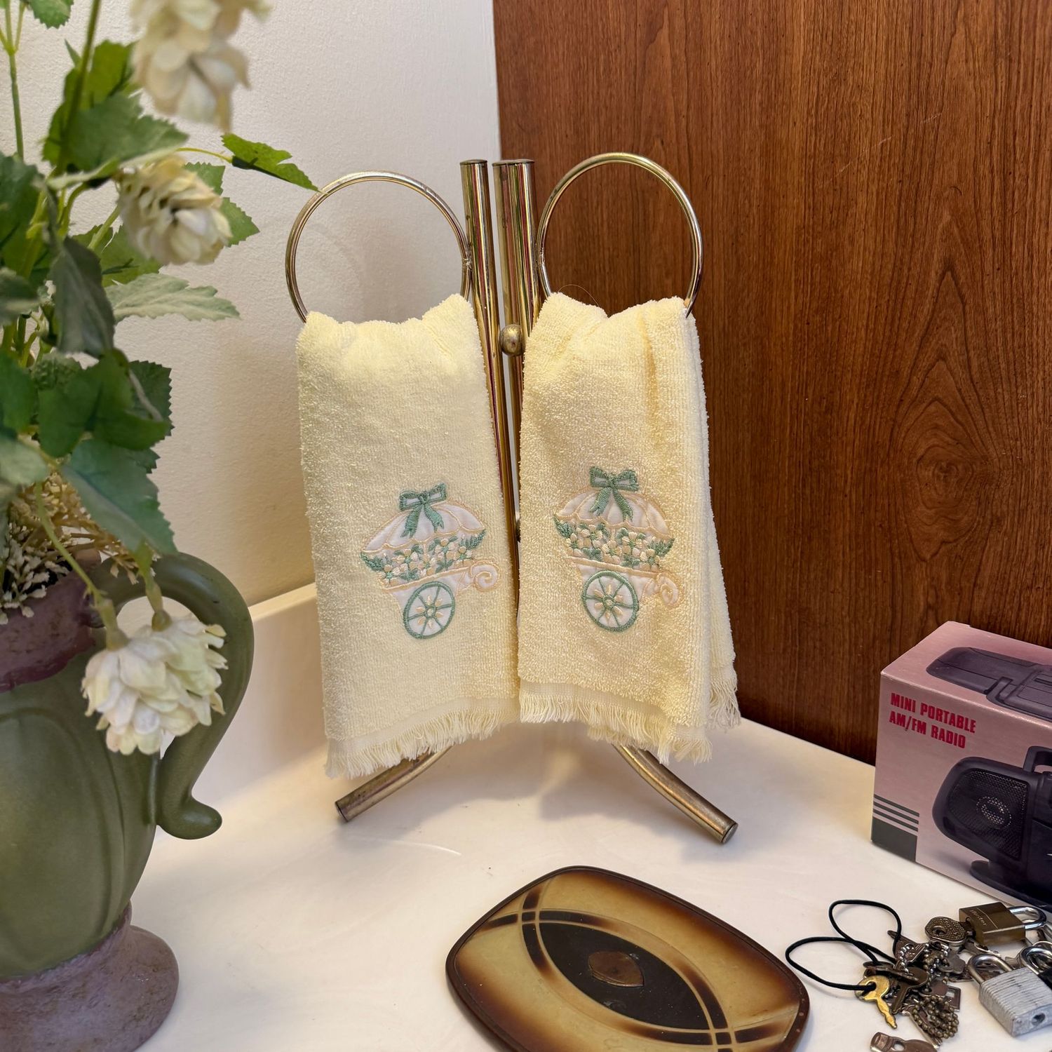 Bath hand-towel ring holder, some wear, and yellow hand towels