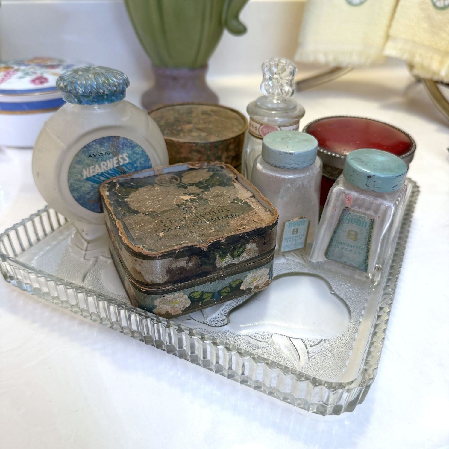 Vintage vanity powder and talc jars, boxes on square glass tray Vintage vanity powder and talc jars, boxes on square glass tray
