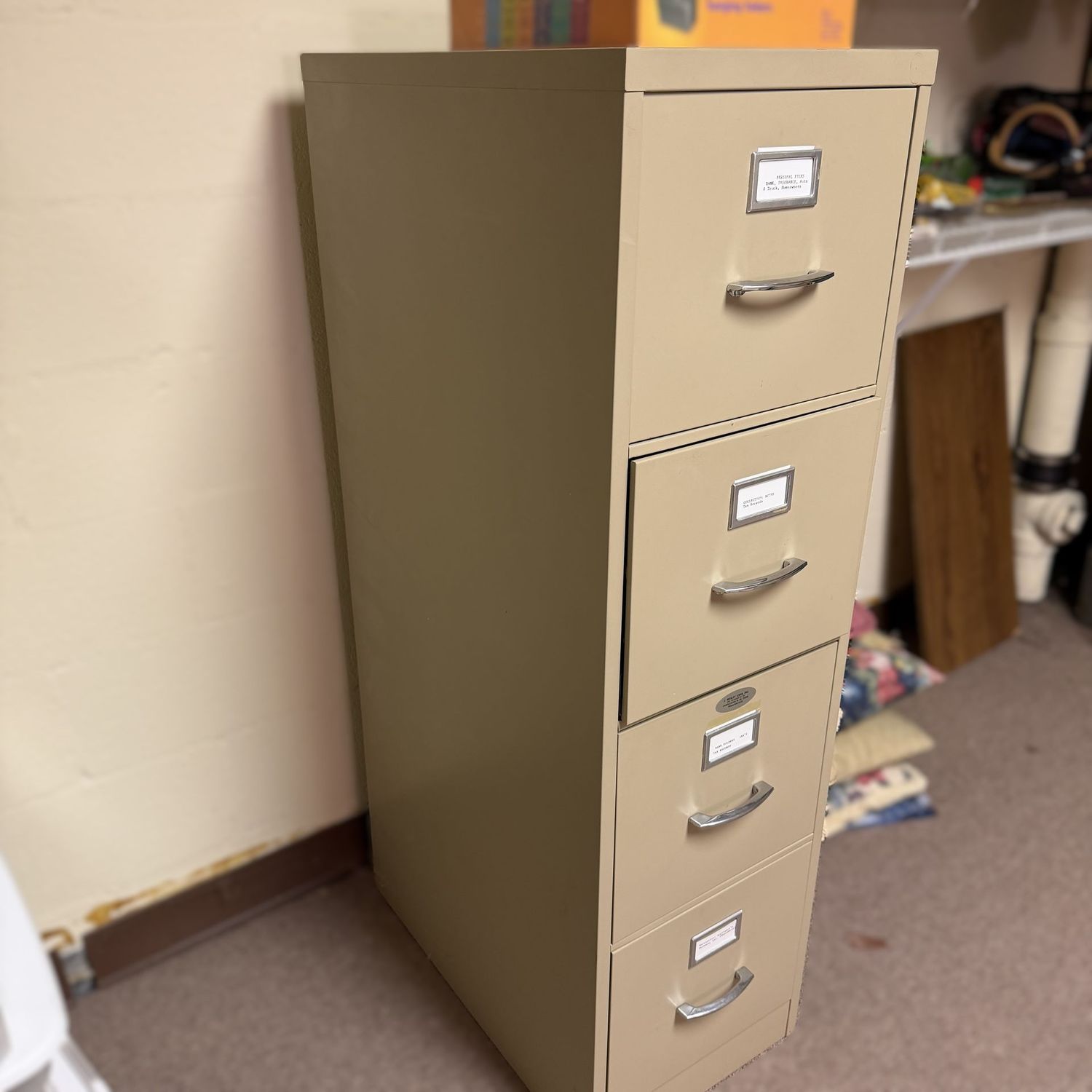 Almond 4-drawer steel file cabinet, nice condition, with extra folders, 50 Almond 4-drawer steel file cabinet, nice condition, with extra folders, 50"H x 15"W x 25"L (This item is heavy and in the lower level - OK to use a dolly)