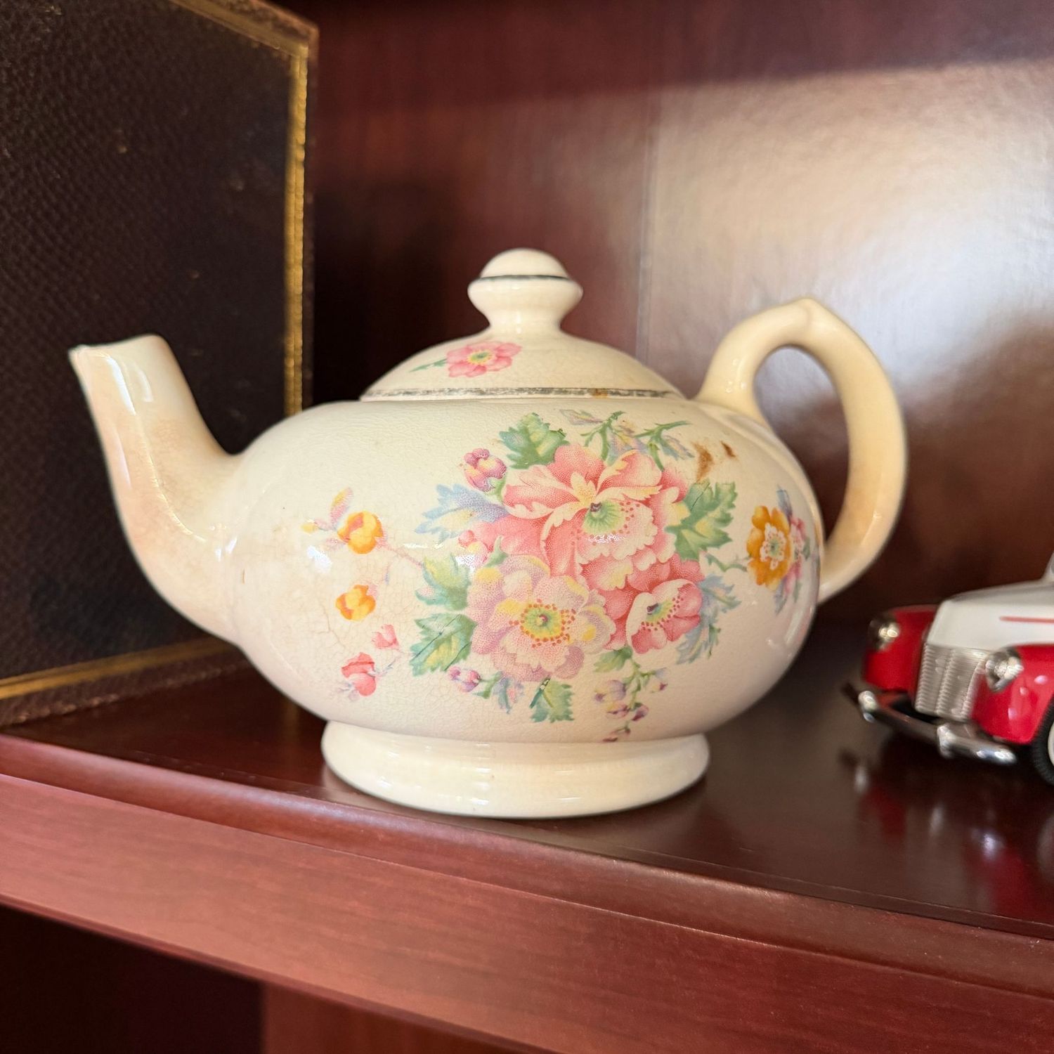 Floral Bakerite teapot, some chips to spout