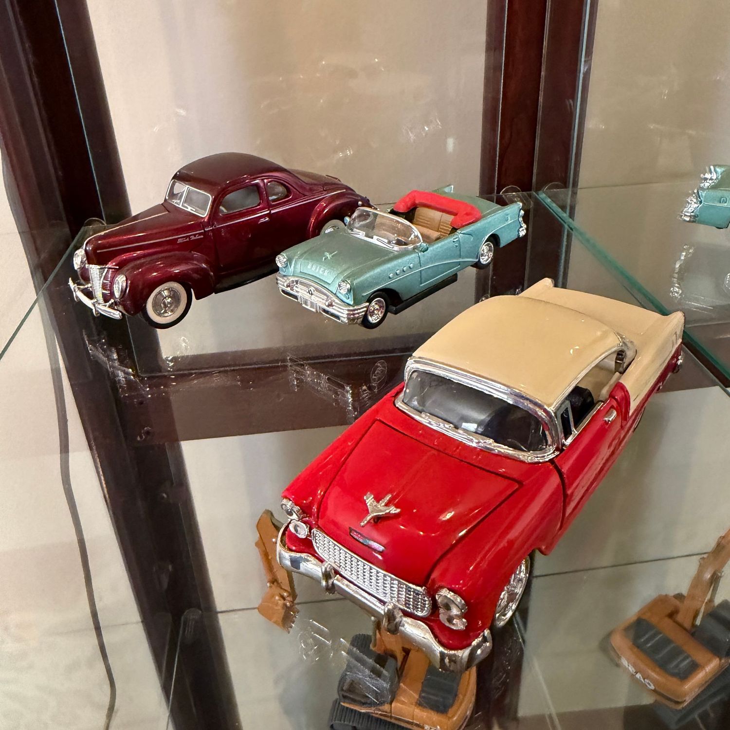 Three model cars, the largest is 4.5"L