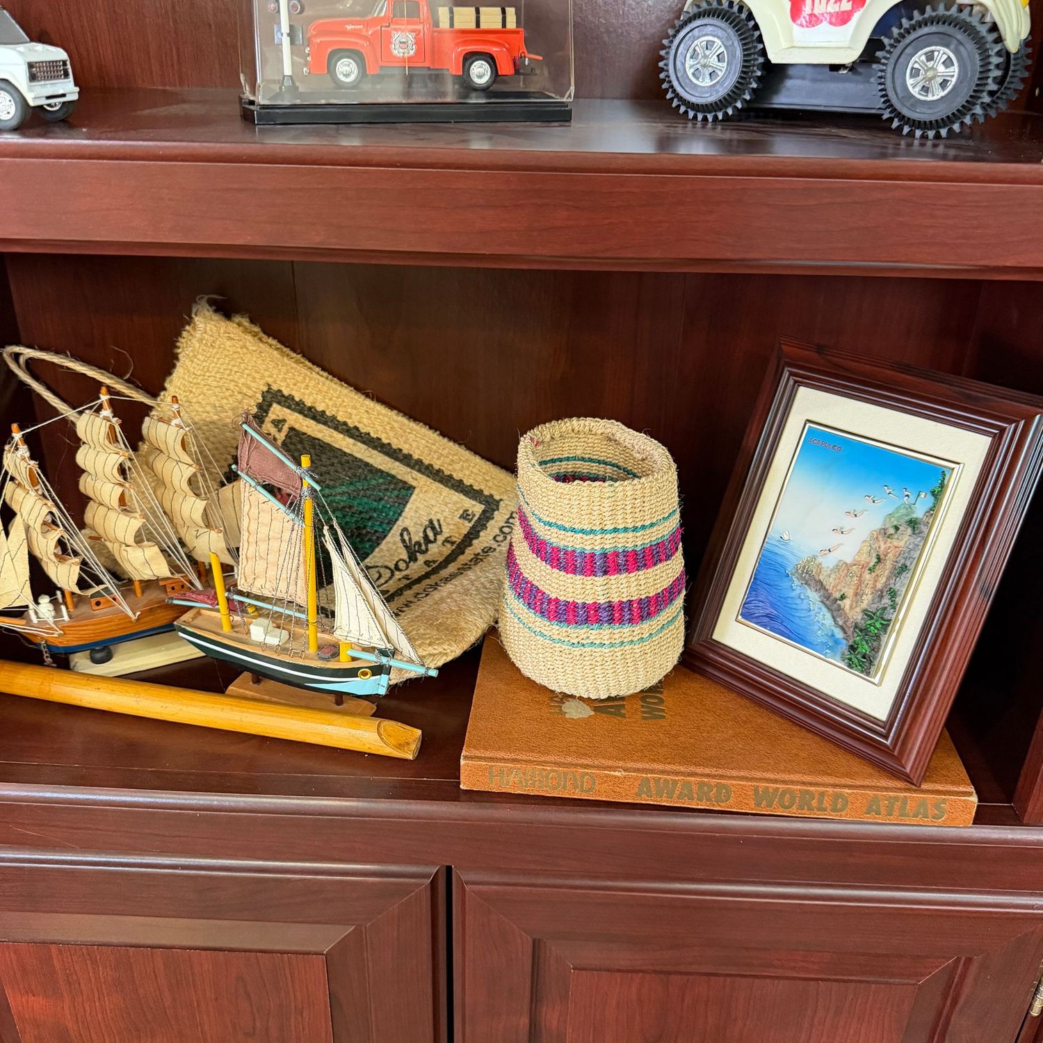 Shelf with world atlas, woven basket, flute, wooden ships, approx. 6"L