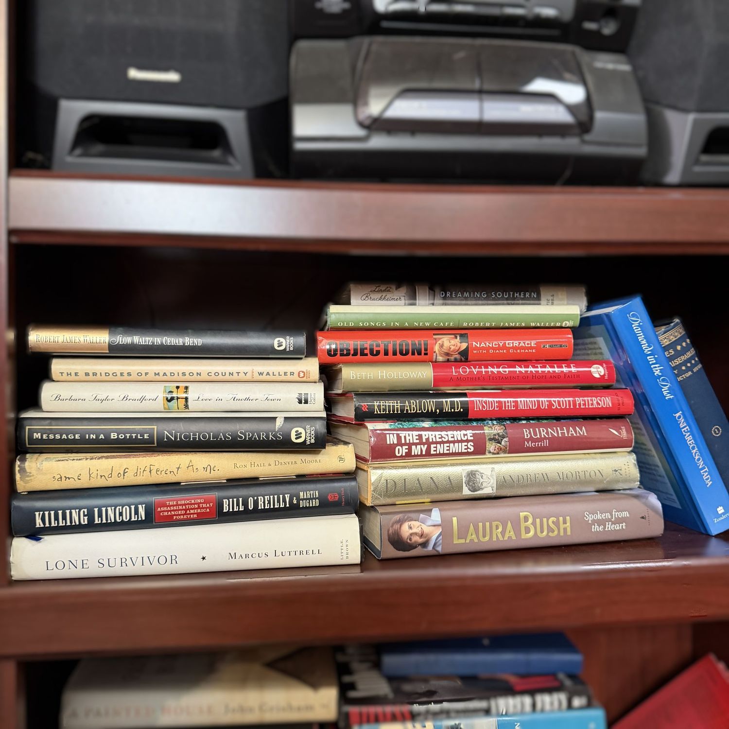 Shelf of books including Killing Lincoln, Laura Bush