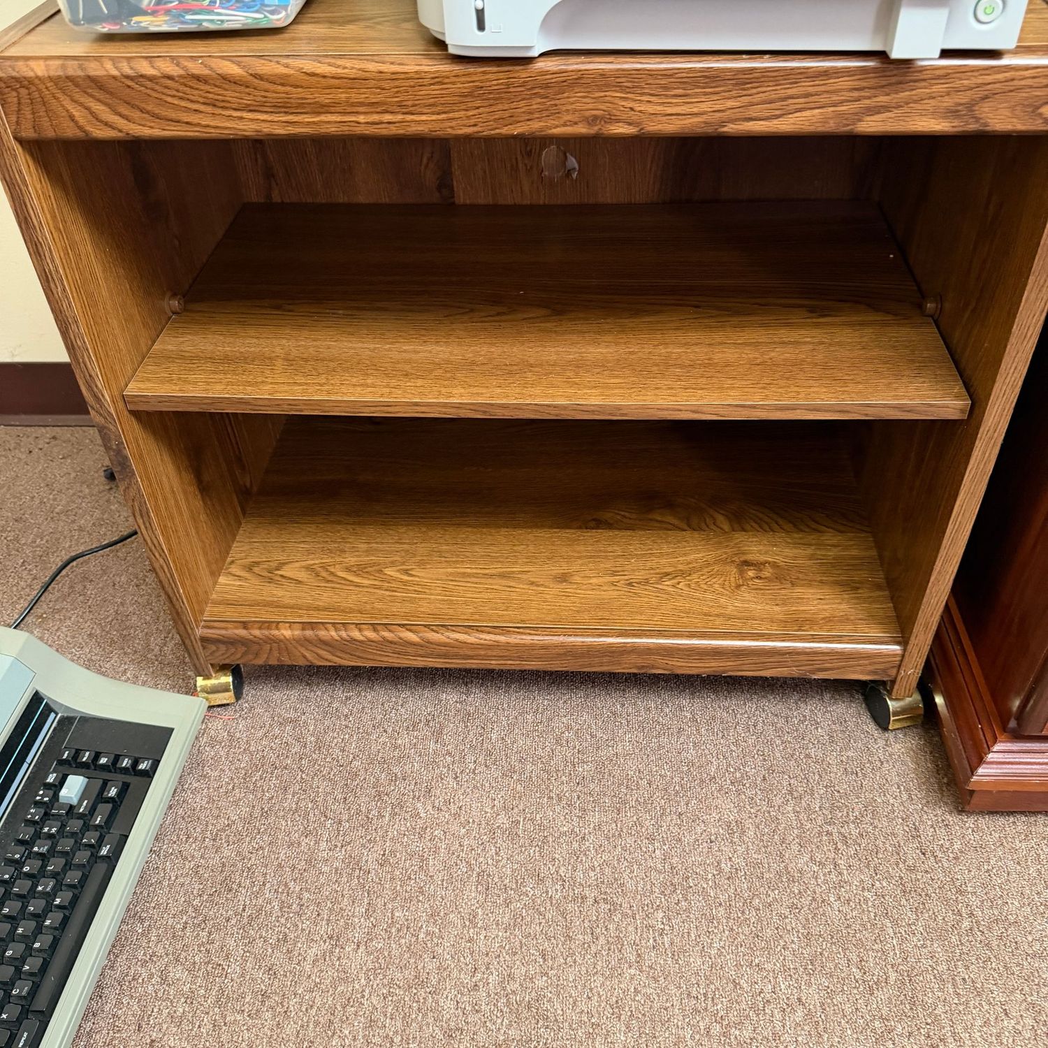 Laminate shelf, on casters, 25"H x 28"L x 16"D (This item is heavy and in the lower level - OK to use a dolly)