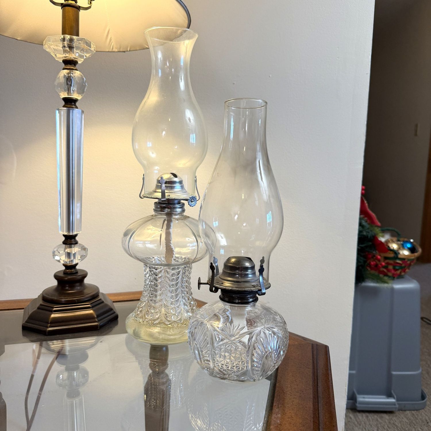 Two clear glass oil lamps, lanterns, the tallest is 16"