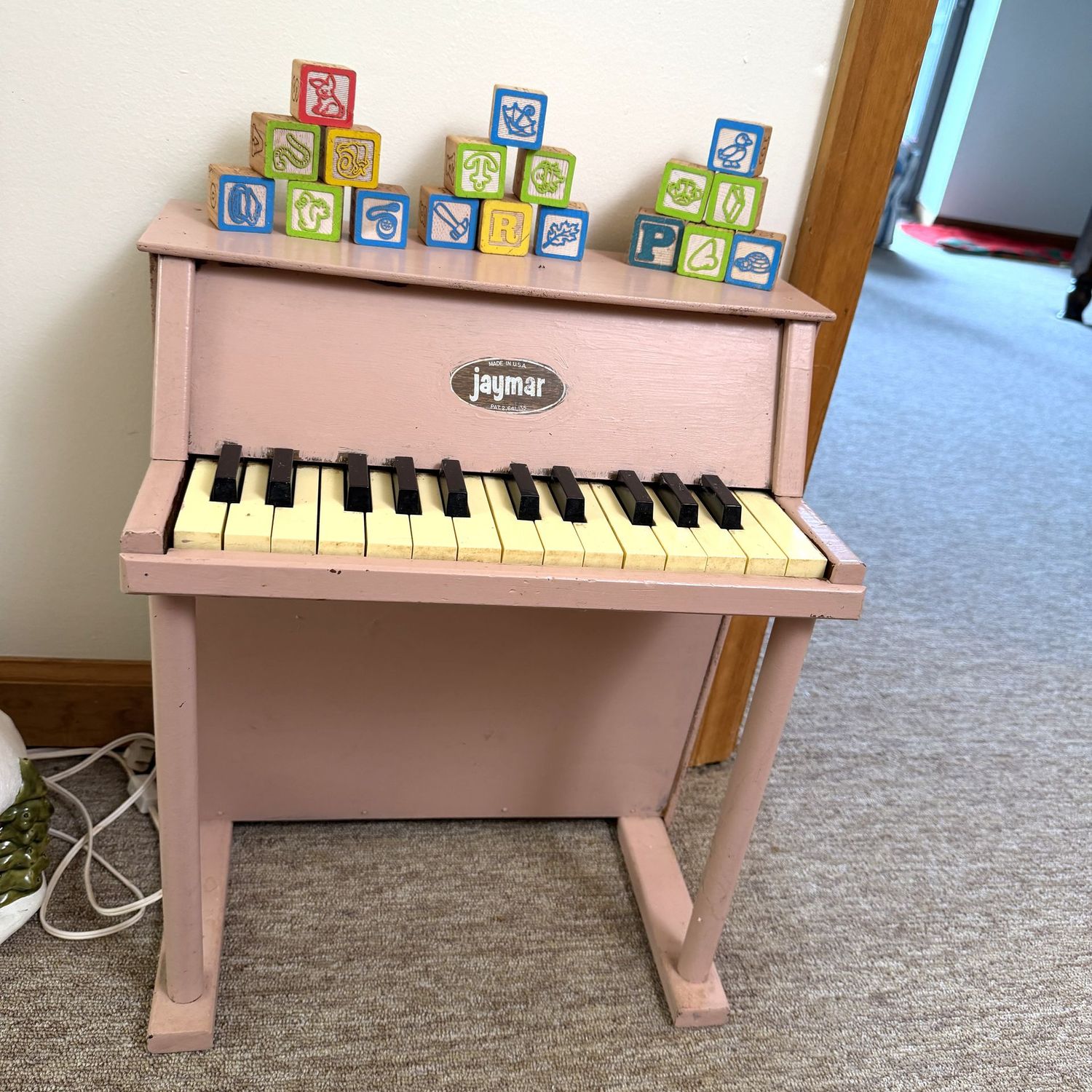 Pink Jaymar child's piano 18"H x 15"W, plays, and wood blocks are included, (This item is in the lower level)