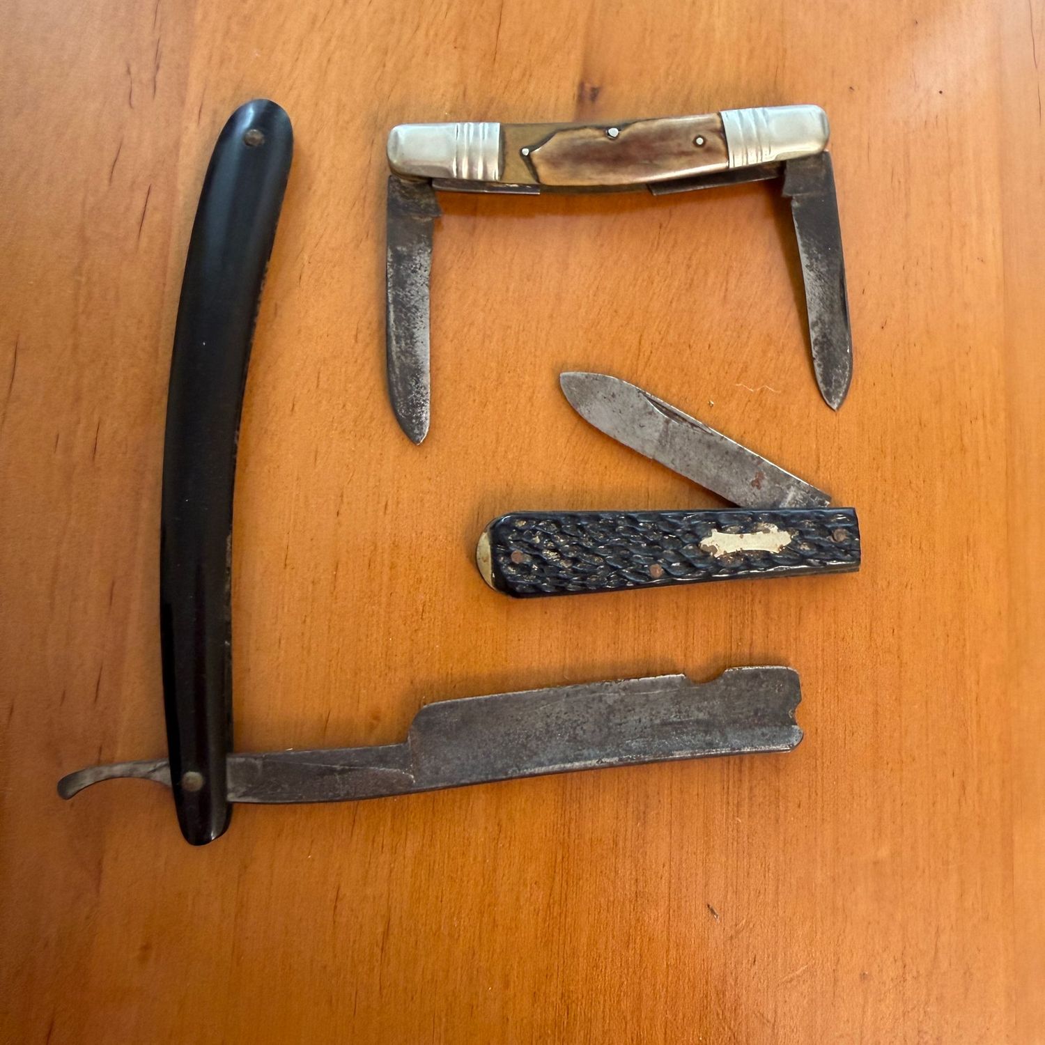 Group of 3 vintage pocket knives and razor, all show chips or wear, great for display