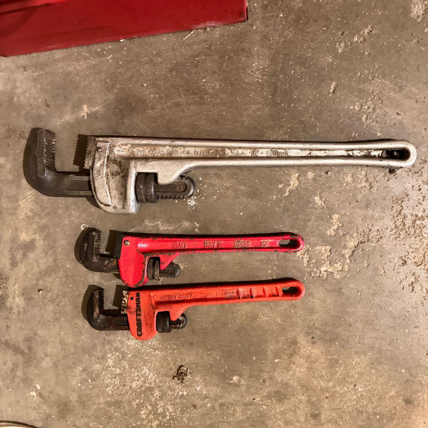 Two red heavy-duty 10 Two red heavy-duty 10" pipe wrenches, and Ridge Tool 18" pipe wrench