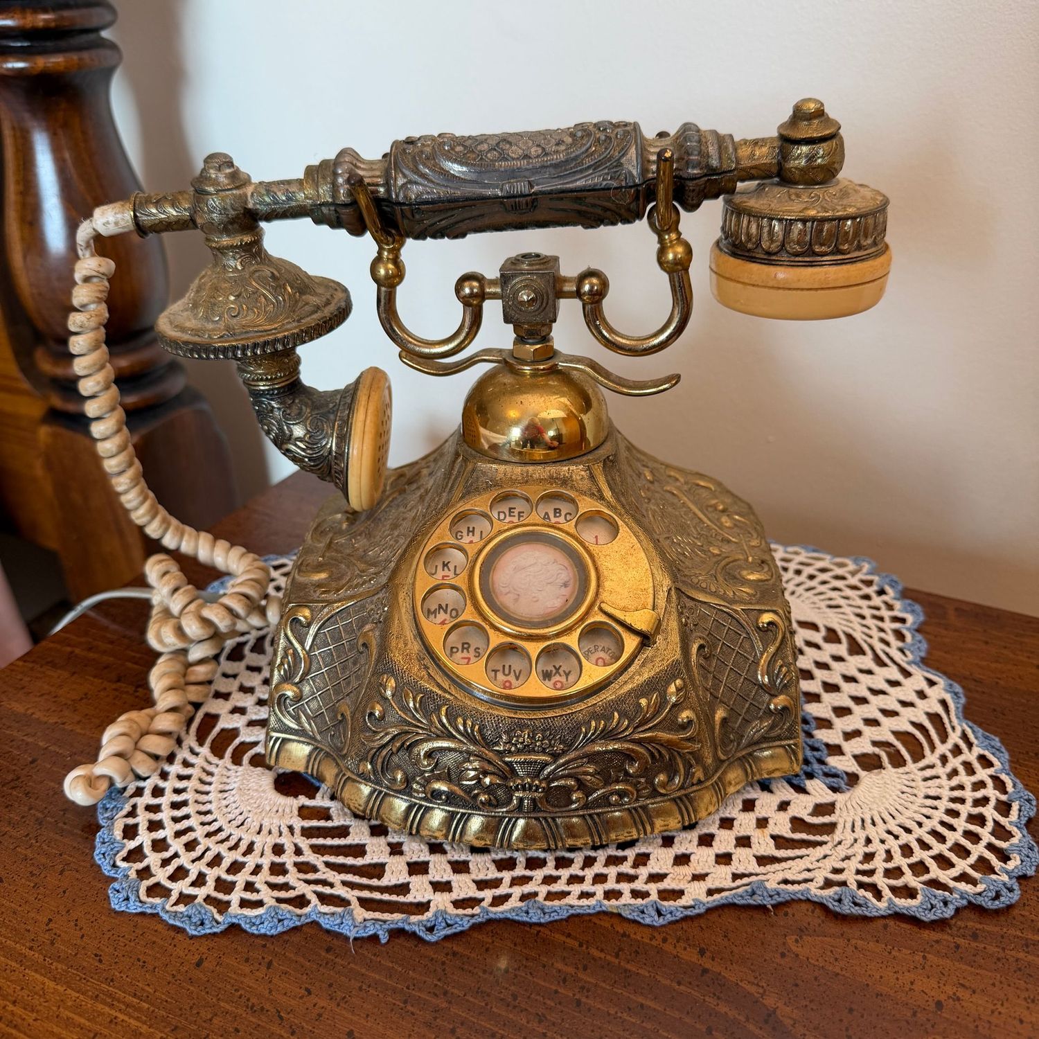 Vintage brass rotary telephone, some wear (especially to the cords)