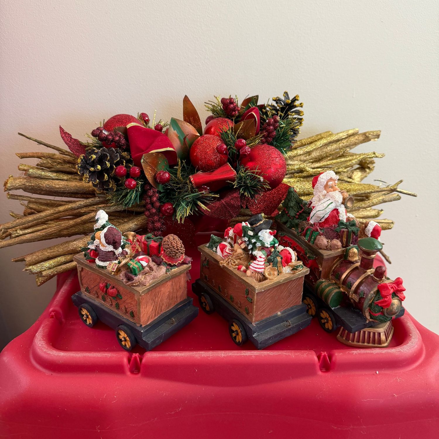Christmas decorations including Santa's train, and mantle/centerpiece with berries and pinecones (18"L)
