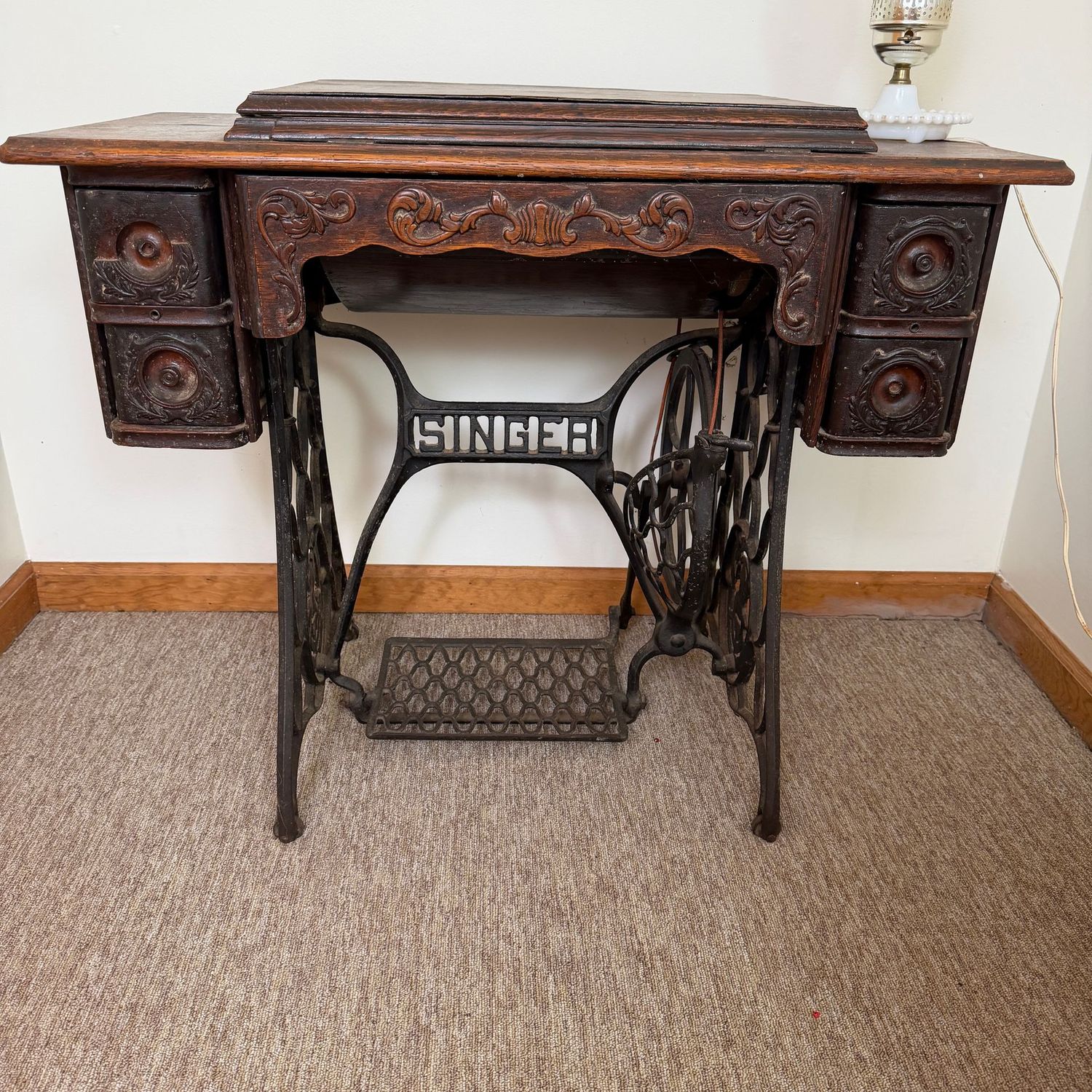 Antique Singer treadel sewing machine, a few knobs missing, sewing machine is very pretty, 34"W (This item is very heavy and in the lower level)