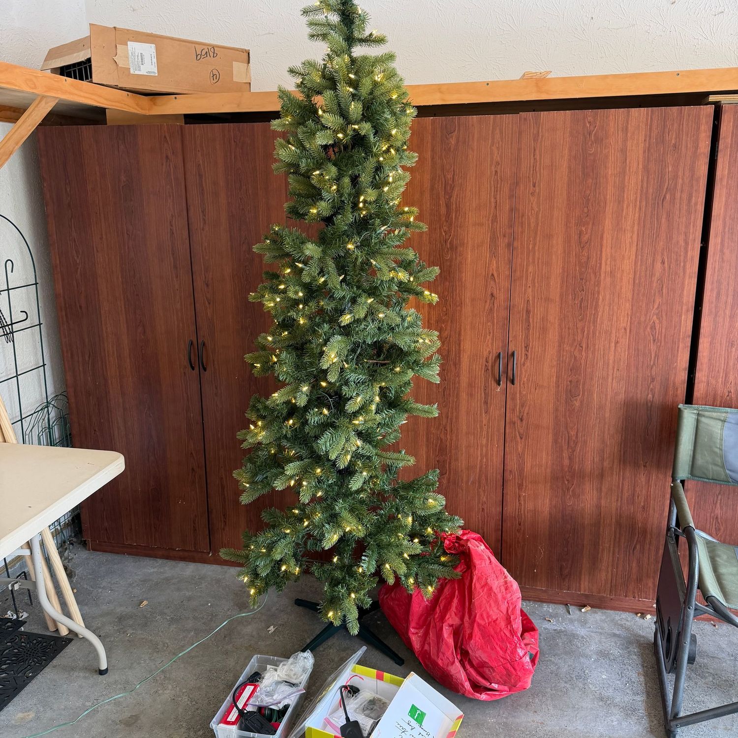Pre-lit slender Christmas tree, assembles quickly, comes with bag, and lighting accessories/cords, 7 ft. x 25 in.