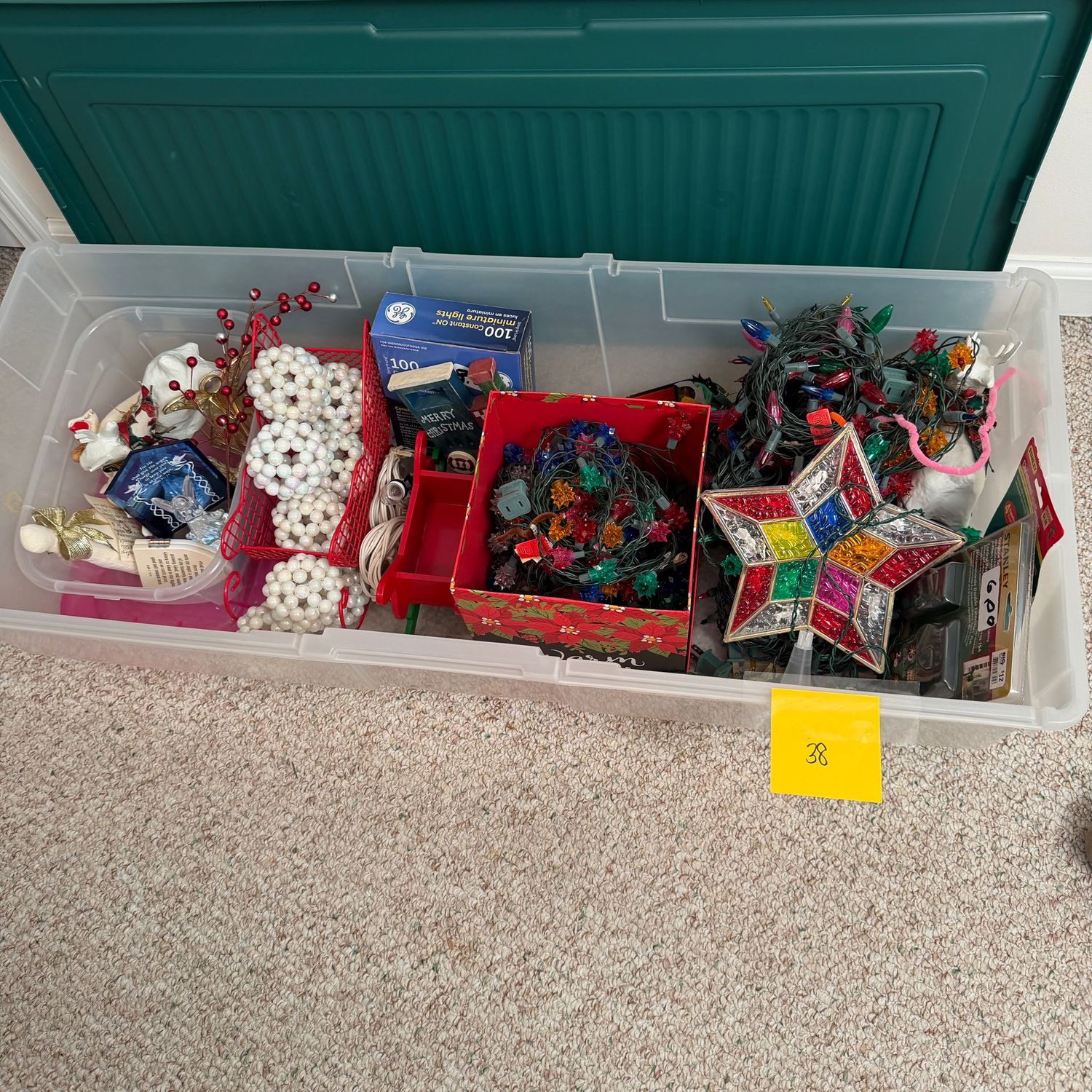 Lot #38, long tote with decorations, ornaments, multi-color lights, star tree topper