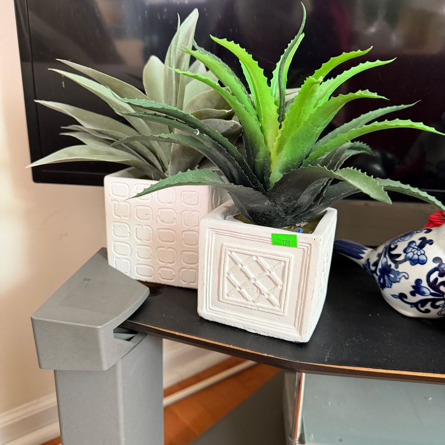 Lot #128, two faux plants in white square planters, 8"