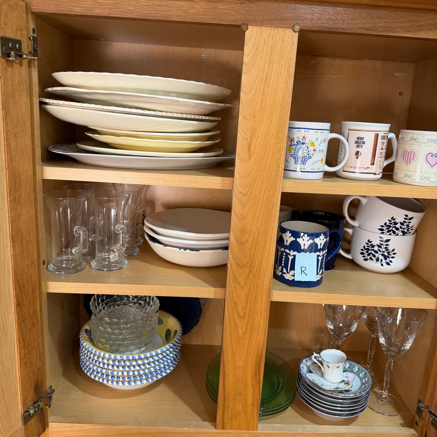 Kitchenware Lot R, Cabinet with a variety of vintage platters, coffee mugs, bowls, stemware, hot chocolate glasses Kitchenware Lot R, Cabinet with a variety of vintage platters, coffee mugs, bowls, stemware, hot chocolate glasses