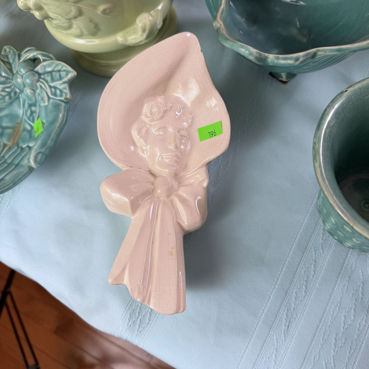 Lot #196, McCoy pottery ivory girl in bonnet wall pocket, 8"