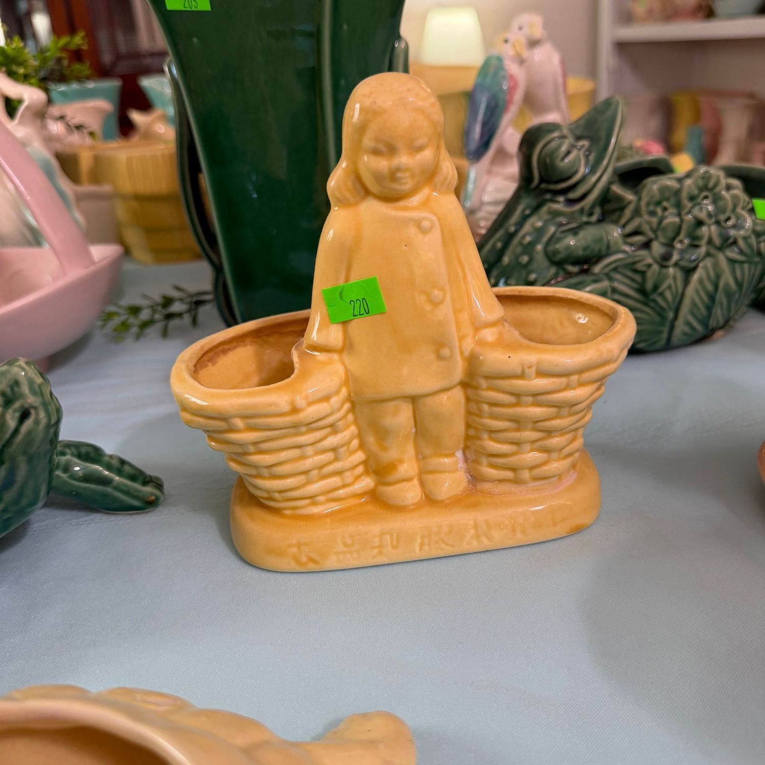 Lot #220, yellow pottery Asian girl planter, 6"H