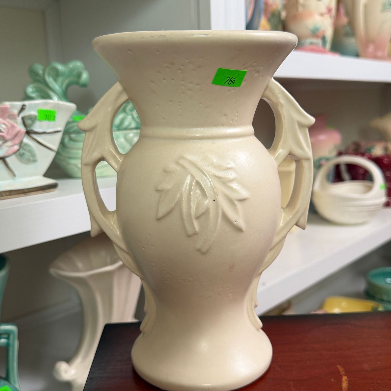 Lot #264, ivory McCoy pottery, embossed, branch-handle vase, 8"