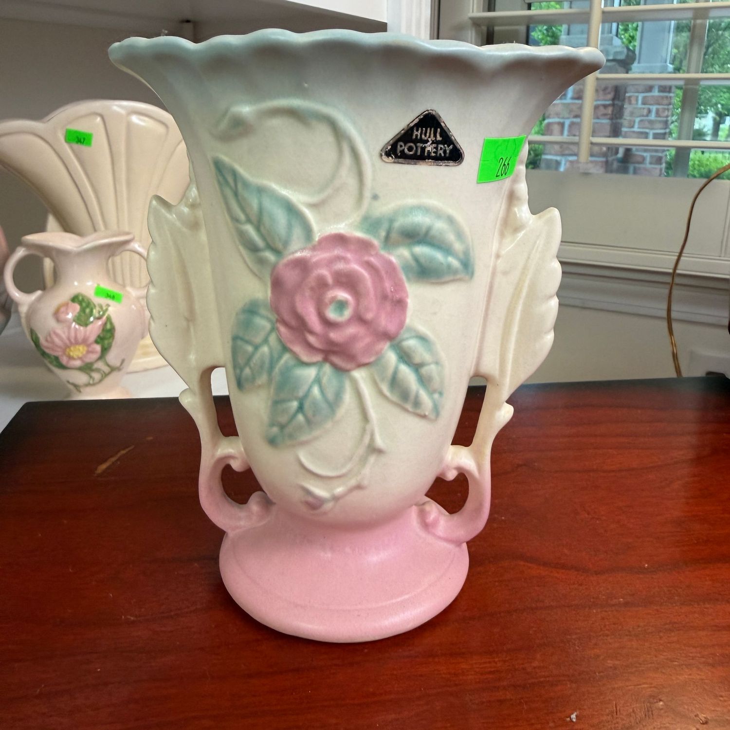 Lot #266, Hull pottery Camelia, rose, leaf double-handle vase, with sticker, 6 1/4"