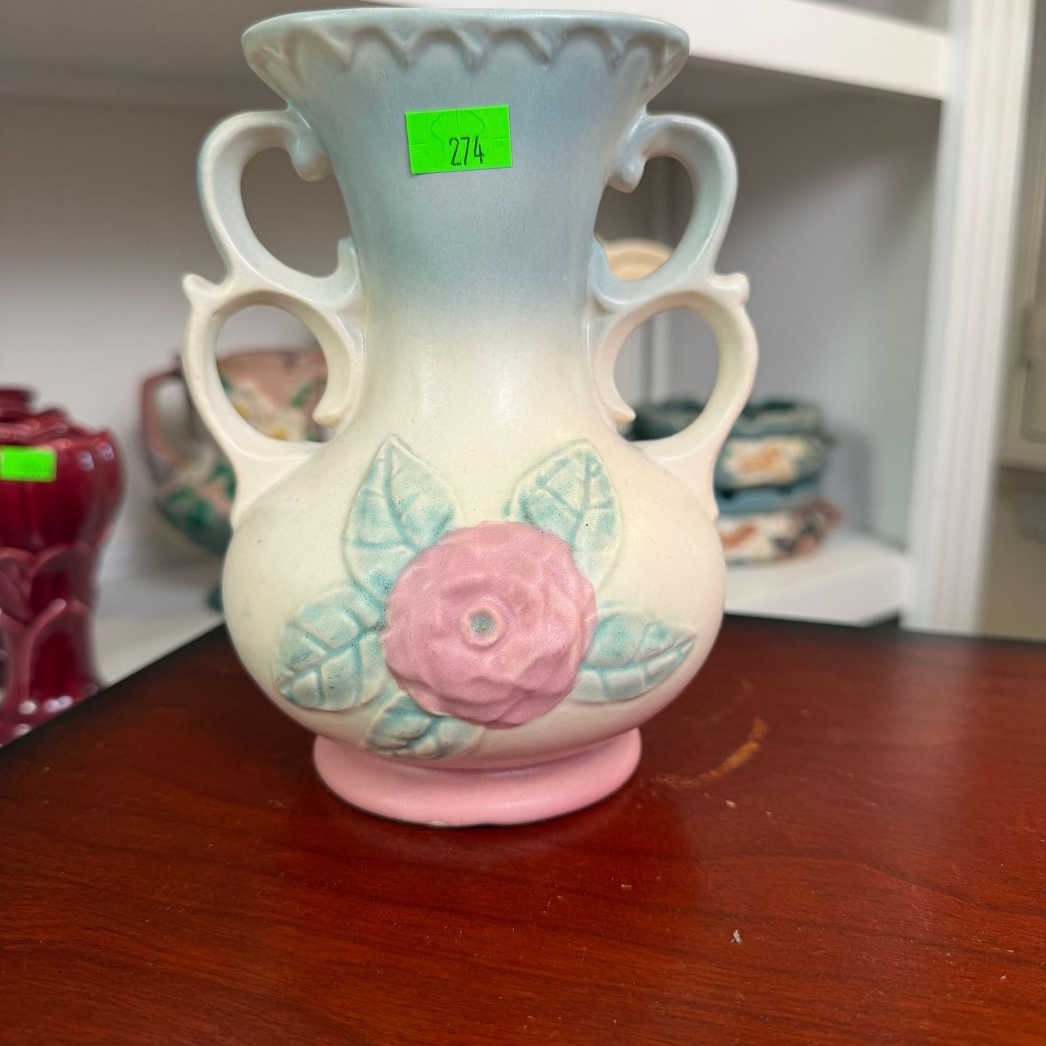 Lot #274, Hull pottery, blue upper, open rose, double-loop handle, vase, 6 1/4 Lot #274, Hull pottery, blue upper, open rose, double-loop handle, vase, 6 1/4"