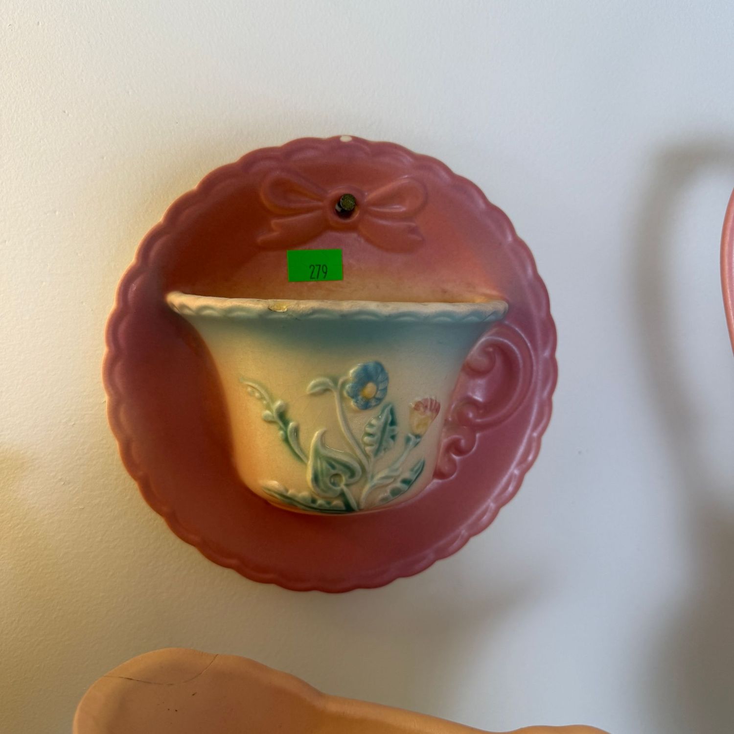 Lot #279, Hull pottery bow knot teacup wall pocket, 6"