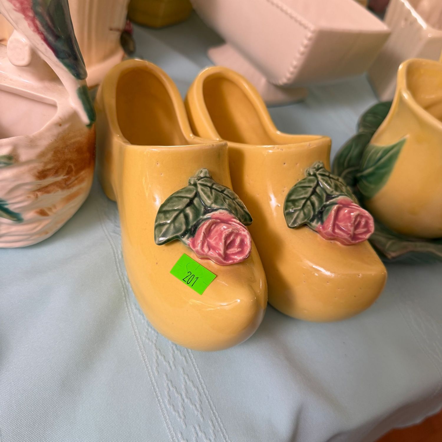 Lot #201, pair of McCoy pottery Dutch shoes with roses, 7 Lot #201, pair of McCoy pottery Dutch shoes with roses, 7"