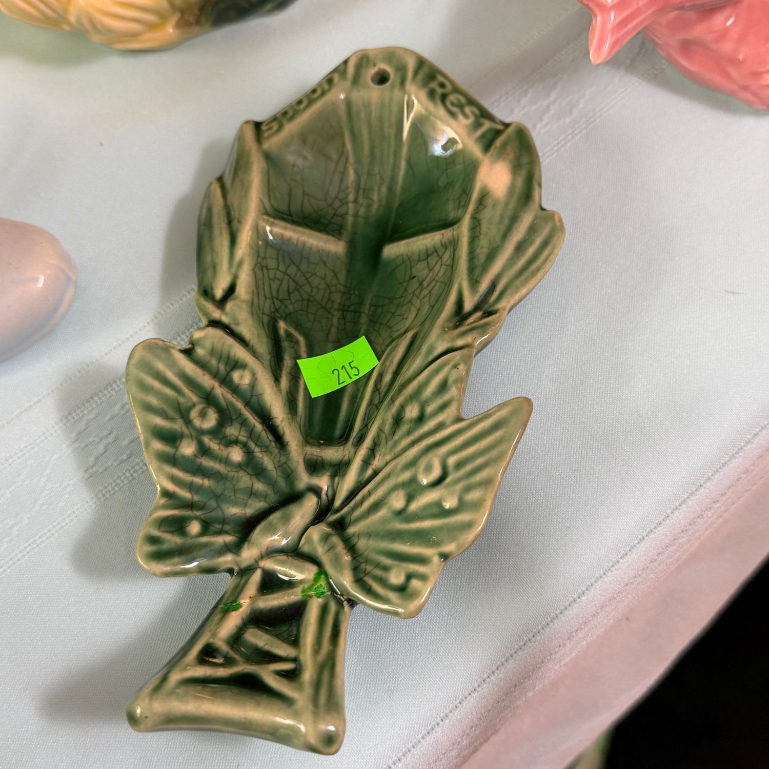 Lot #215, McCoy pottery green spoon rest, has a repair on the handle, 7.5"L