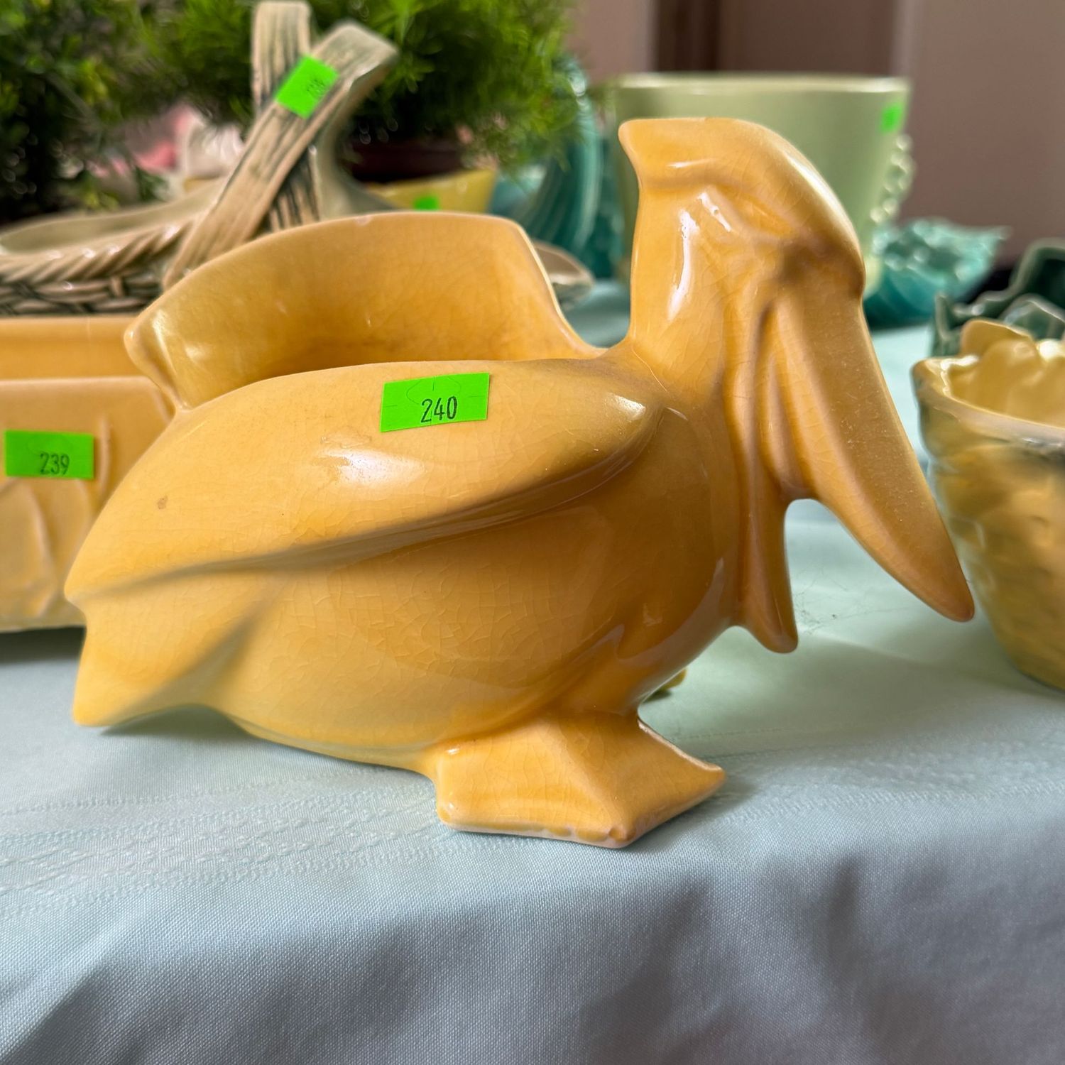 Lot #240, Nelson McCoy yellow pottery pelican planter, minor chip, 4.5"H
