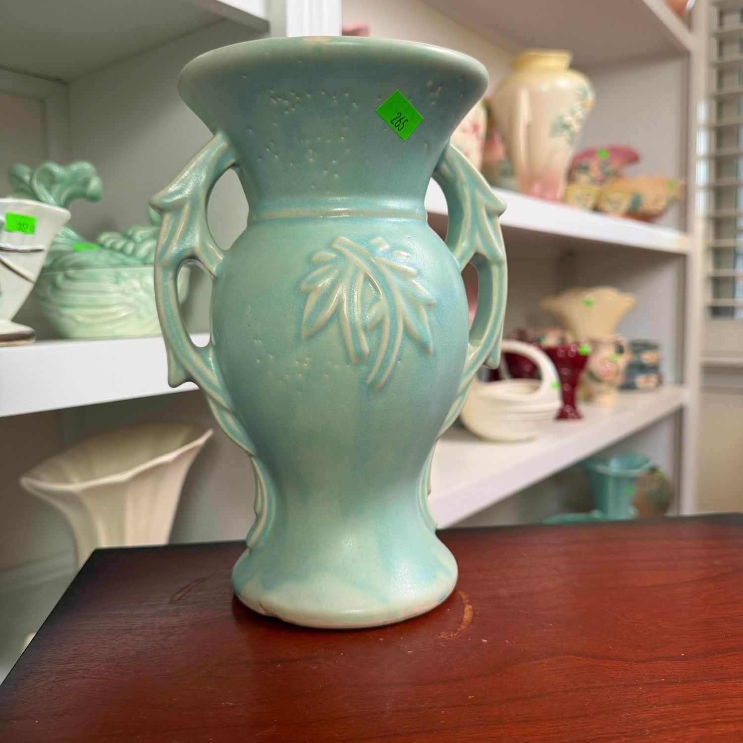 Lot #265, teal McCoy pottery, embossed, branch-handle vase, 8"