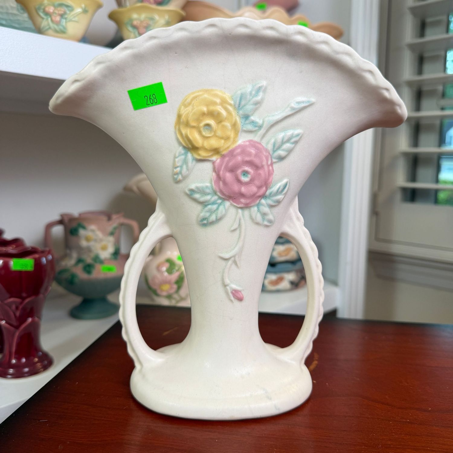 Lot #268, Hull pottery Camelia, open rose, scalloped-handle, fan vase, 8 1/2"