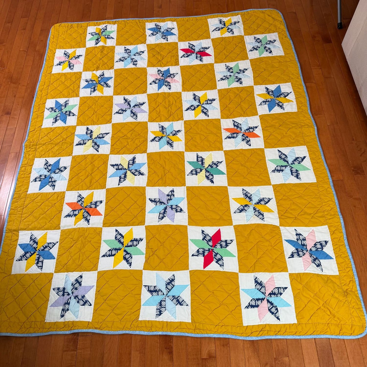 Patchwork star quilt with mustard, gold background, 6'8" x 5'2"