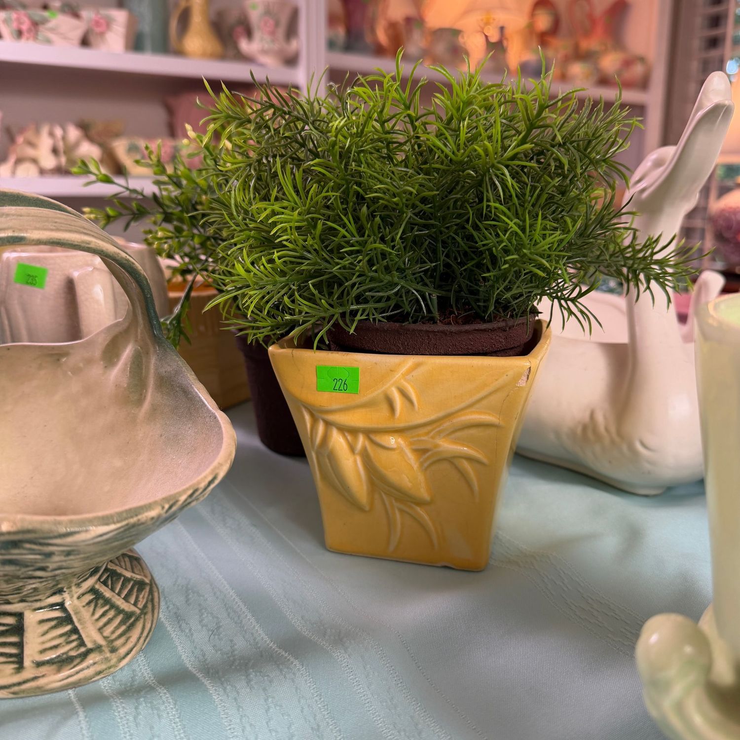 Lot #226, yellow McCoy pottery fig & leaves planter, minor chip, some hairlines, 4"H, with faux fern
