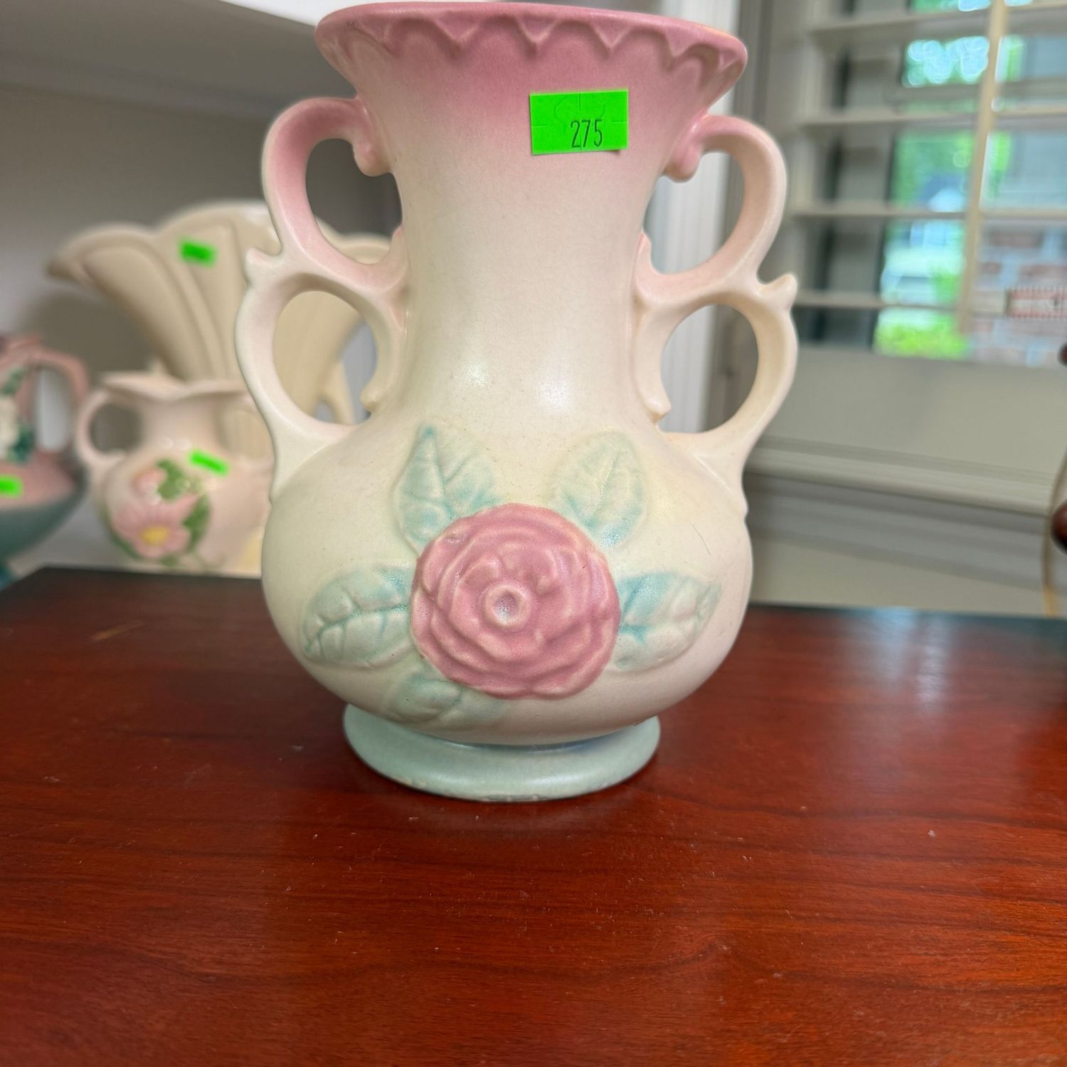 Lot #275, Hull pottery, pink upper, open rose, double-loop handle, vase, 6 1/4 Lot #275, Hull pottery, pink upper, open rose, double-loop handle, vase, 6 1/4"